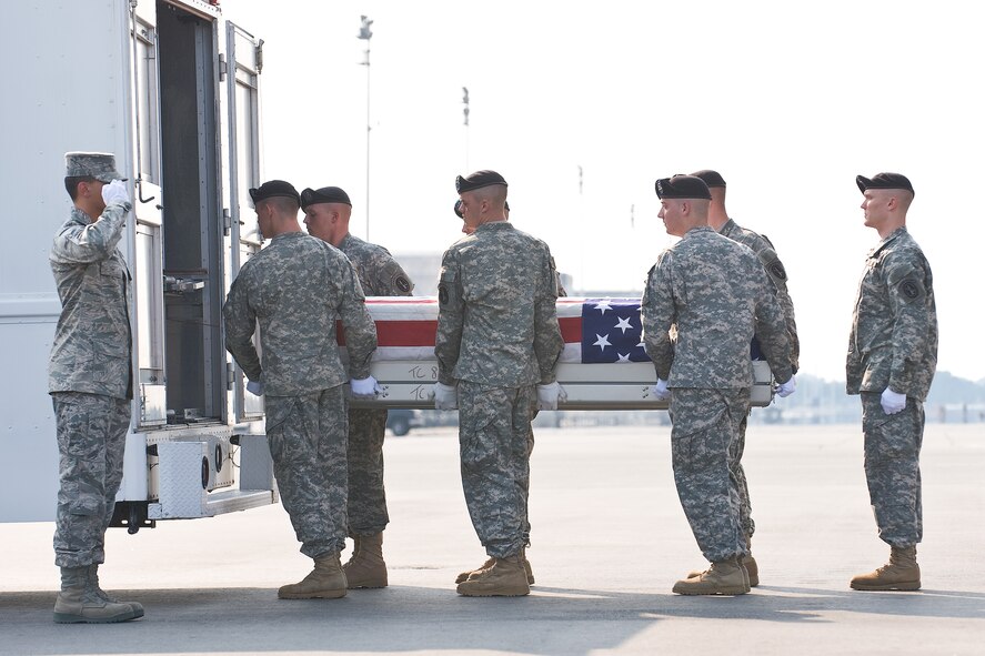 A U.S. Army carry team transfers the remains of Army Spc. Clayton D. McGarrah, of Harrison, Ark., at Dover Air Force Base, Del., July 6. Spc. McGarrah was assigned to the 2nd Battalion, 508th Parachute Infantry Regiment, 4th Brigade Combat Team, 82nd Airborne Division, Fort Bragg, N.C. (U.S. Air Force photo/Roland Balik)