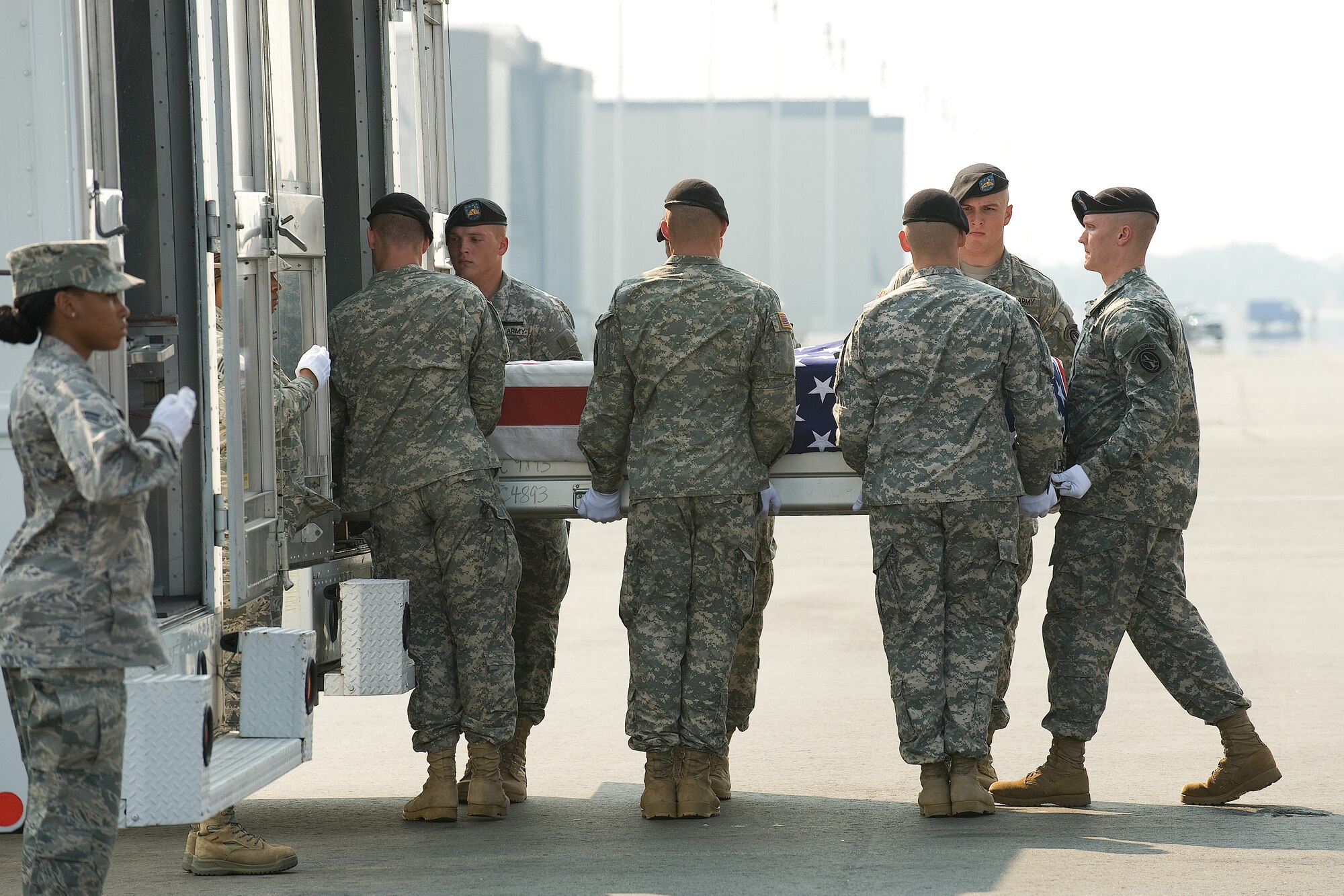7 July 2010  USAF Photo by Jason Minto.  A U.S. Army carry team transfers the remains of Army PFC Edwin C. Wood of Omaha, NE at Dover Air Force Base, Del., July 7, 2010.  