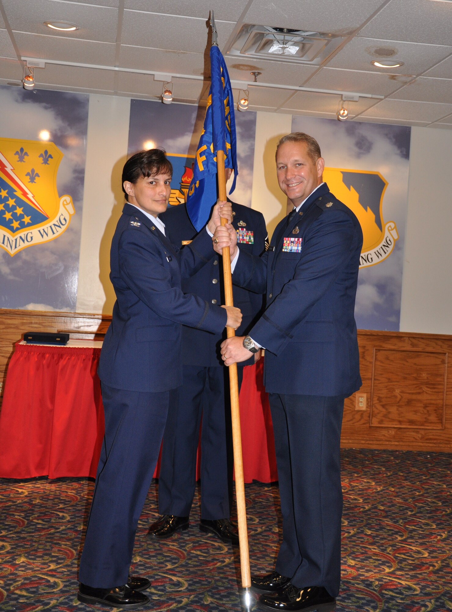 Lt. Col. Erik Bovasso (right), takes command of the 82nd Force Support Squadron from Col. Kimberley Ramos (left), 82nd Mission Support Group commander, during a change of command ceremony held in the Sheppard Club at Sheppard Air Force Base, Texas, July 12, 2010. The 82nd FSS provides personnel and manpower support to Team Sheppard and Combat Commanders across the globe. The incoming commander was previously the Force Development Division chief of the Headquarters Joint Special Operations Command, Fort Bragg, N.C. (U.S. Air Force photo/Airman 1st Class Valerie Hosea)