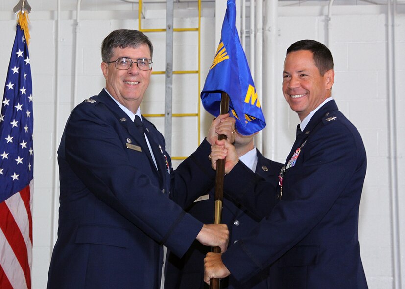 (Right) Lt. Col. James Hurley, outgoing 911th Mission Support Group commander, hands the 911 MSG guidon to Col. Gordon Elwell, 911th Airlift Wing commander, during a change of command ceremony, July 11. By handing the guidon off, Colonel Hurley relinquishes command of the 911 MSG. (U.S. Air Force photo/Senior Airman Joshua J. Seybert)