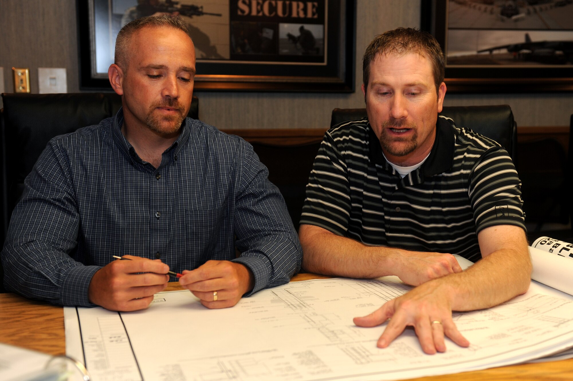 MINOT AIR FORCE BASE, N.D. -- P.J. Pallotta, 5th Bomb Wing antiterrorism officer, and Timothy Allen, 91st Missile Wing antiterrorism officer, review security procedures here June 24. Team Minot was recently selected as Air Force Global Strike Command’s 2009 Best Antiterrorism Program of the Year. (U.S. Air Force photo by Tech. Sgt. Lee A. Osberry, Jr.)
