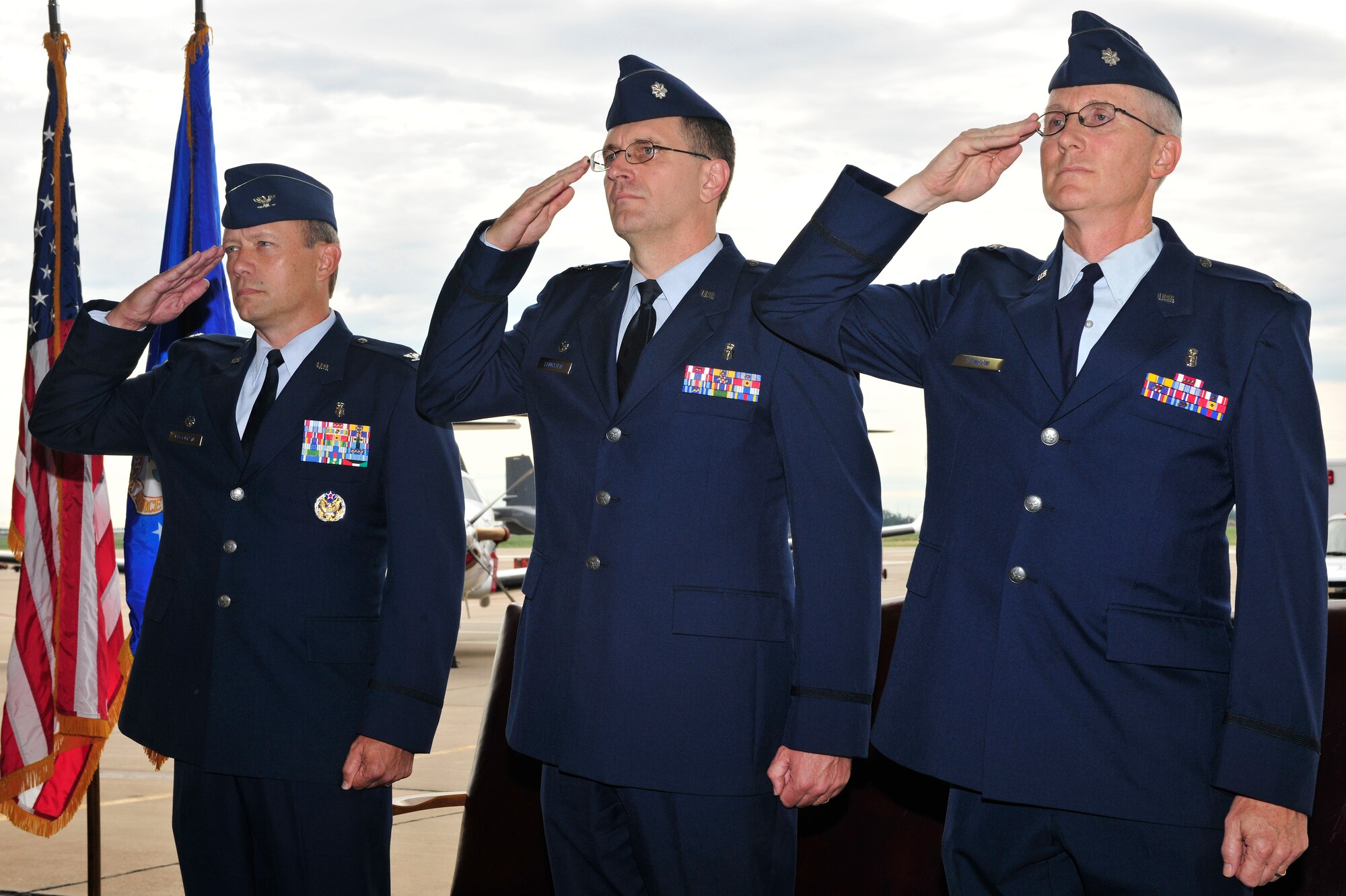 (from left to right) U.S. Air Force Col. Scott Corcoran, 27th Special Operations Medical Group commander, U.S. Air Force LtCol. Randall Langsten, 27th Special Operations Aerospace Medicine Squadron  (27th SOADMS) outgoing commander, and U.S. Air Force LtCol. Jeffrey Stinson, 27th SOAMDS incoming commander salute at the beginning of a change of command ceremony, July 15, 2010.  The change of command ceremony is a time-honored tradition that allows the unit to witness the old commanders relinquish their position and for new commanders to assume their roles over the squadron. (U.S. Air Force photo by Tech. Sgt. Josef Cole)(Released)