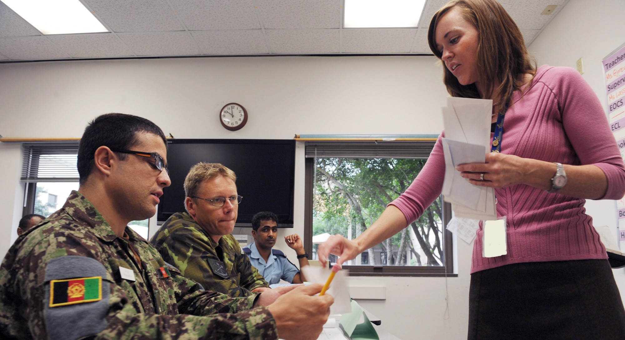 International military students receive a class assignment from Andrea Gjorevski as she asks questions during a general English class recently at the Defense Language Institute at Lackland Air Force Base, Texas.  Mrs. Gjorevski is a general English section instructor. (U.S. Air Force photo illustration/Staff Sgt. Desiree N. Palacios) 