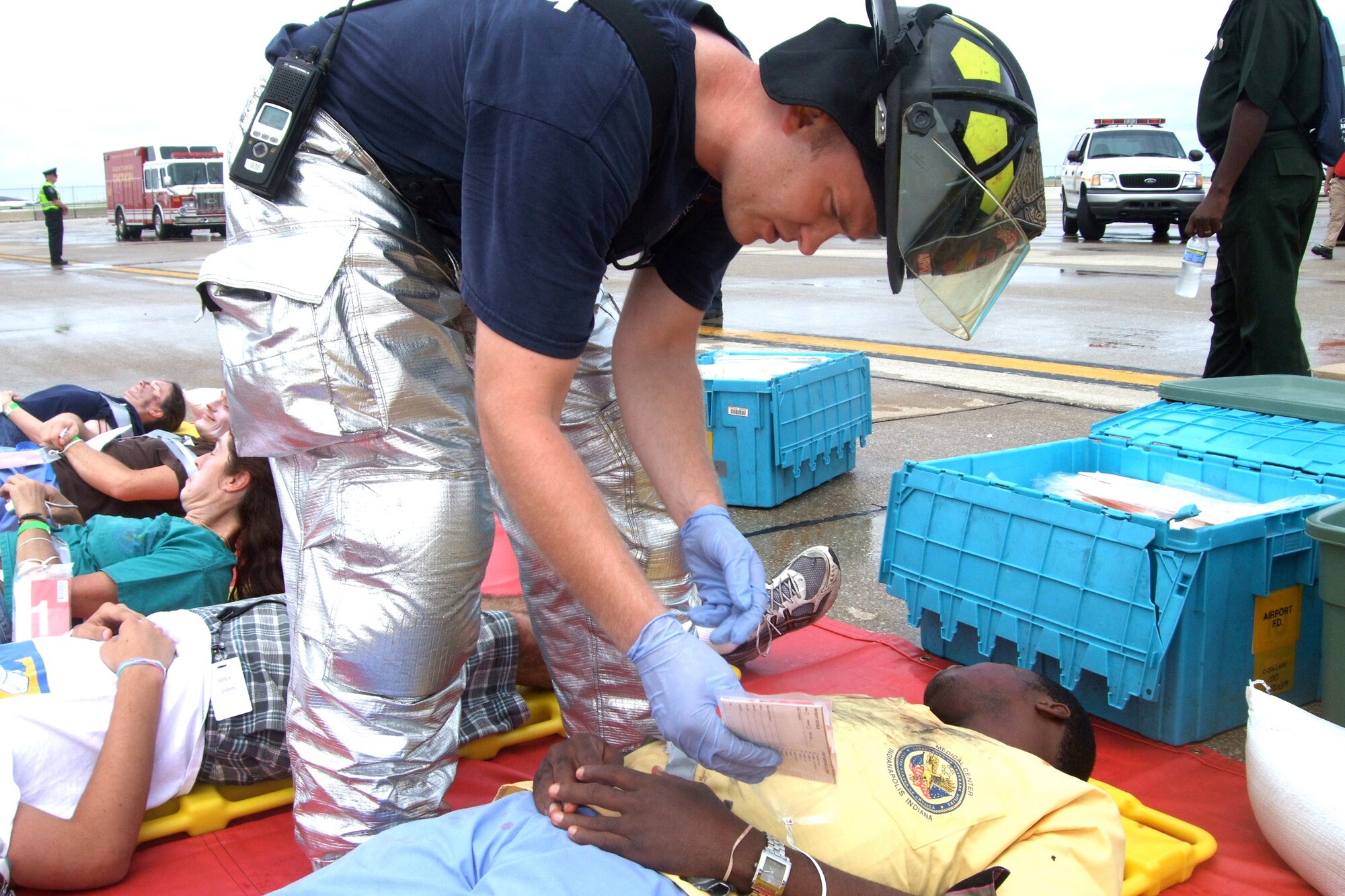 Mike Swardson, a firefighter and emergency medical technician with
Indianapolis International Airport Fire Department evaluates  "victim"
Obinna Okoro from Nigeria during the mass casualty exercise Jun. 22 in
Indianapolis. (U.S. Air Force photo by Maj. Paula Kurtz)"
