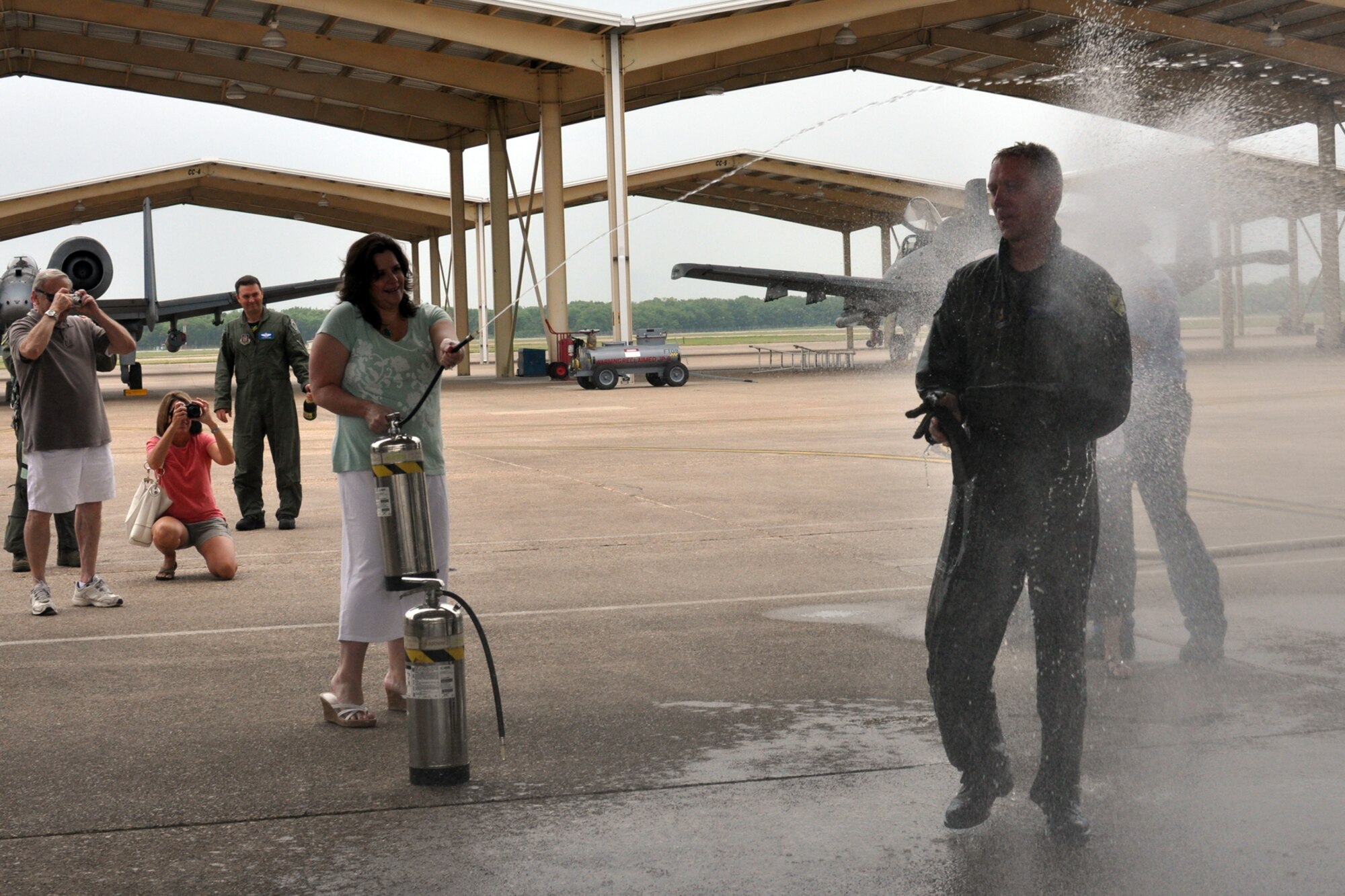 Lt. Col. Michael Schultz, 47 Fighter Squadron, flight commander, gets soaked by family and friends after completing his final flight at the 47th FS on Barksdale Air Force Base, July, 10, 2010. Colonel Schultz is leaving the 47th FS and continuing his service to the Air Force at Moody Air Force Base, Ga. (U.S. Air Force photo/Senior Airman Crystal Jordan)  