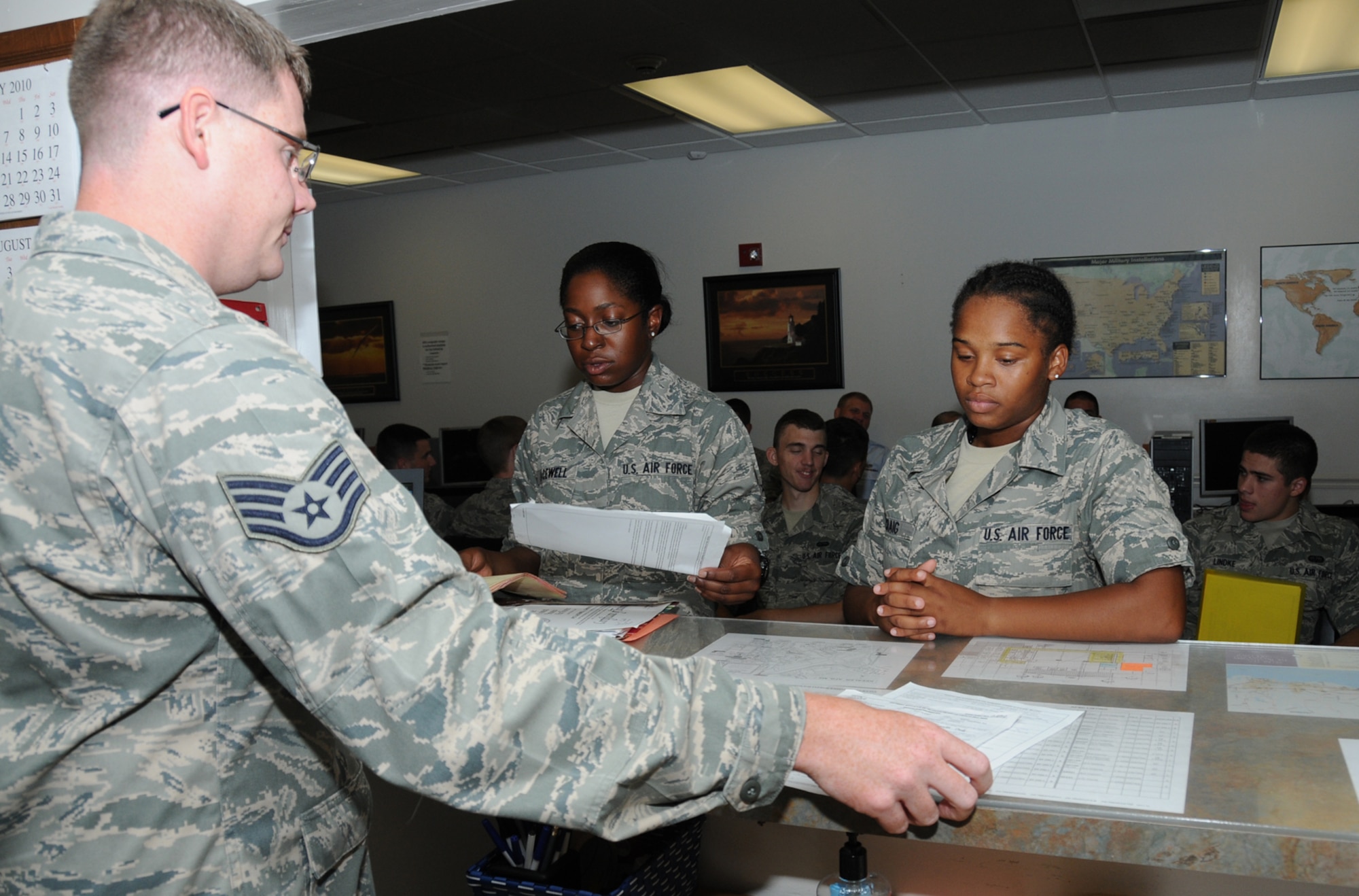 From left, Staff Sgt. Jacob Williams, left, helps Airman 1st Class Candice Lacewell and Airman Basic Denelle Craig, students from the 334th TRS, with their outprocessing at the student personnel center in the Levitow Training Support Facility.  (U.S. Air Force photo by Kemberly Groue)