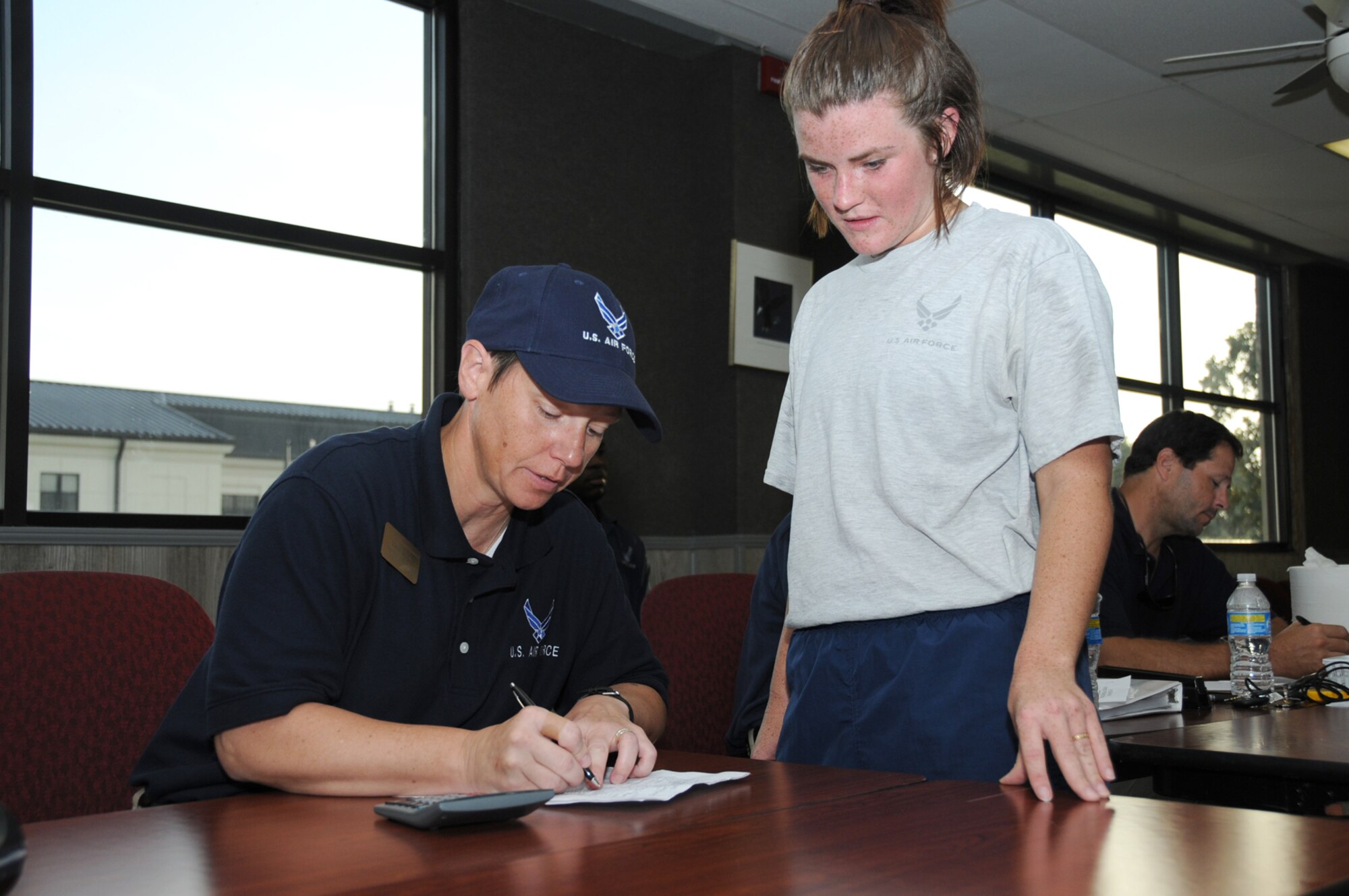 Vicki Jacob, 81st FSS, tallies the fitness test score of Senior Airman Jillian Balderas, 45th Airlift Squadron, at Vandenberg Community Center Monday.  Airman Balderas achieved a score of 97.6.  (U.S. Air Force photo by Kemberly Groue)