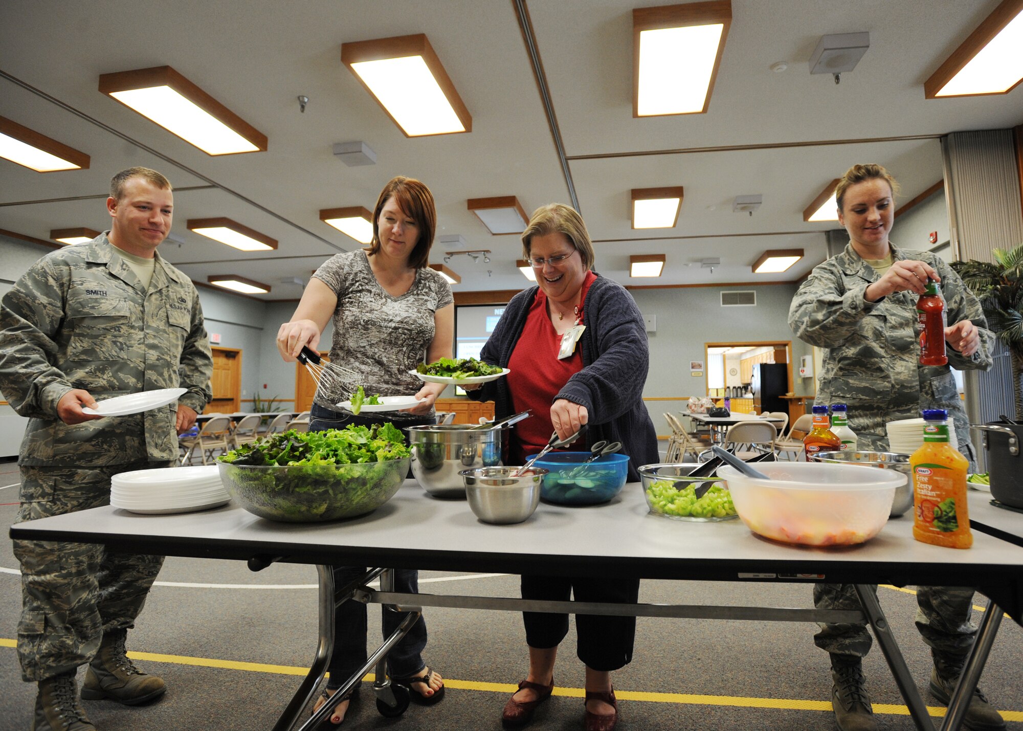 Team McConnell members serve themselves food during the first “Single Parents Network” luncheon at the base chapel, June 29, 2010, McConnell Air Force Base, Kan.  The Single Parents Network is a new program that helps single parents build their local network.  Luncheons occur the last Tuesday of each month and are free to participants. SPN is open to all McConnell’s single parents including active-duty, Guard, Reserve, civilians, contractors and dependents.  (U.S. Air Force photo/Airman 1st Class Andrea Salazar)