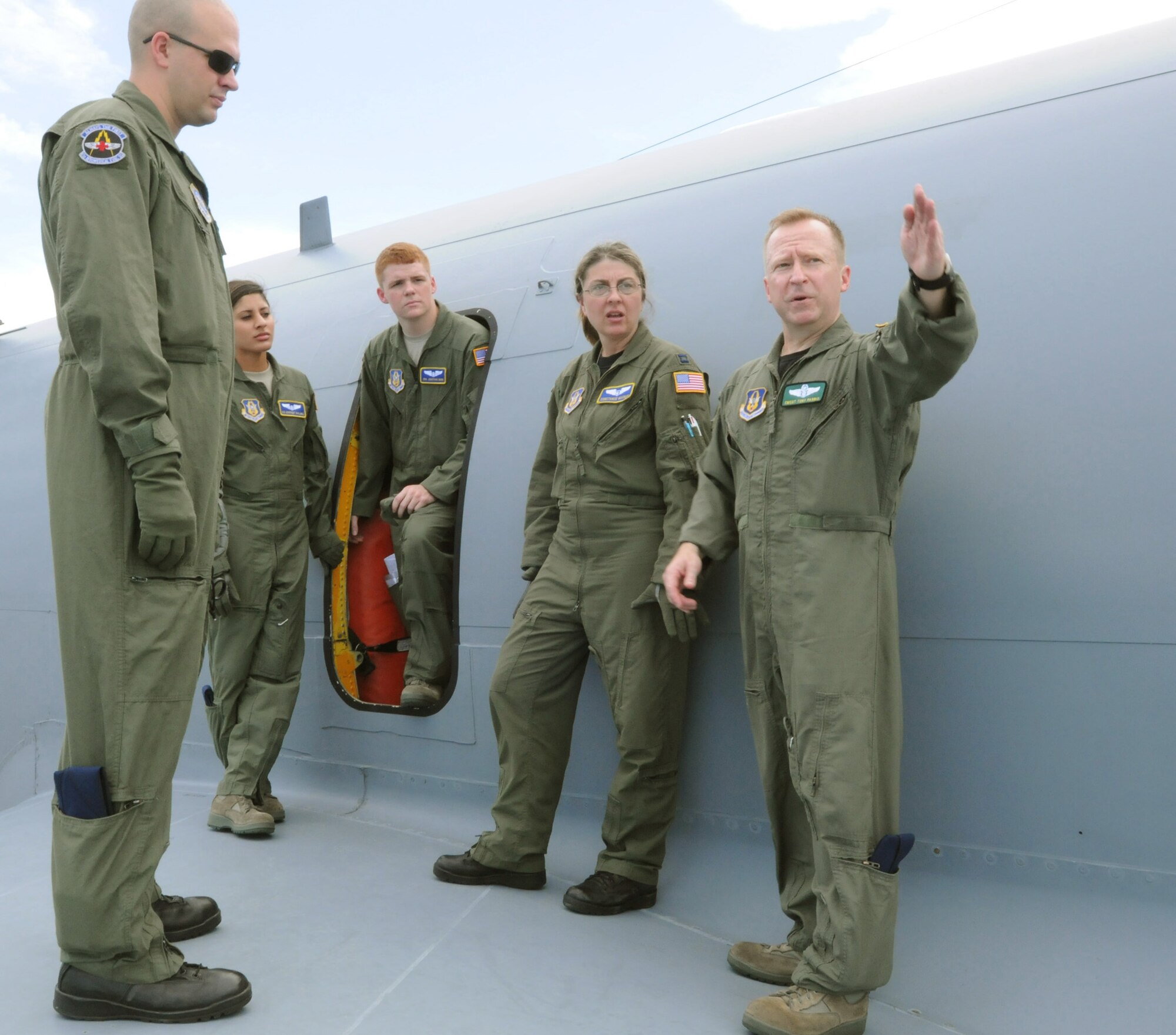 Chief Master Sgt. Tony Parris shows Airmen from the 36th Aeromedical Evacuation Squadron and the 43rd AES how to safely exit a KC-135R Stratotanker in the event of an emergency landing June 26, 2010 at Melbourne, Fla. The 459th AES also participated in the blended training by providing hands-on instruction on patient support pallet operations. Chief Parris is a boom operator assigned to the 77th Air Refueling Squadron. (U.S. Air Force photo/Staff Sgt. Steve Lewis)