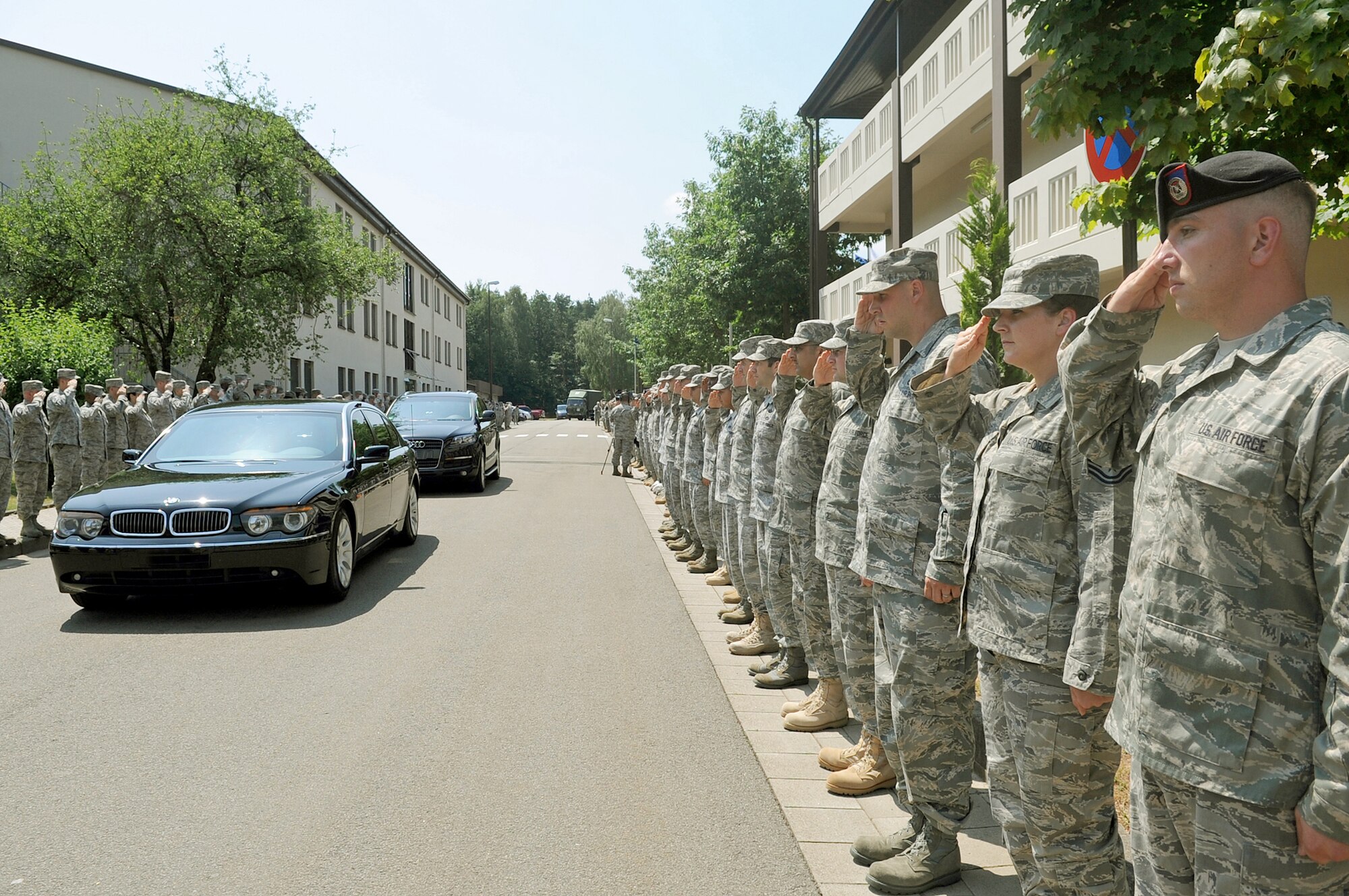 U.S. Air Forces in Europe Airmen salute Gen. Roger A. Brady July 14, 2010 as he leaves the Kisling NCO Academy auditorium after receiving his Order of the Sword invitation at Kapaun Air Station, Germany. General Brady is the U.S. Air Forces in Europe commander. (U.S. Air Force photo illustration/Airman 1st Class Grovert Fuentes-Contreras) 