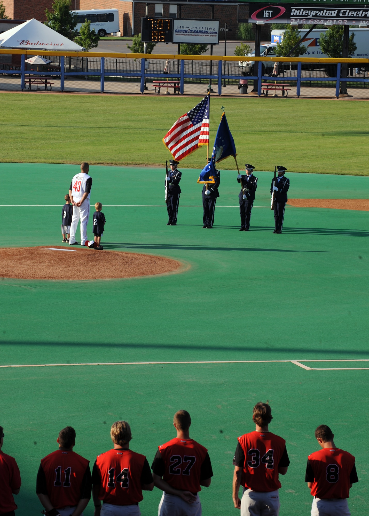 McConnell’s base honor guard presents the colors for the National Anthem during a Wichita Wingnuts baseball game, July 10, 2010, Wichita, Kan.  Before the game, Staff Sgt. Farley, 22nd Civil Engineer Squadron explosive ordnance disposal operator, was recognized as a hometown hero for his numerous deployments and ability to disable explosives.  (U.S. Air Force photo/Airman 1st Class Andrea Salazar)