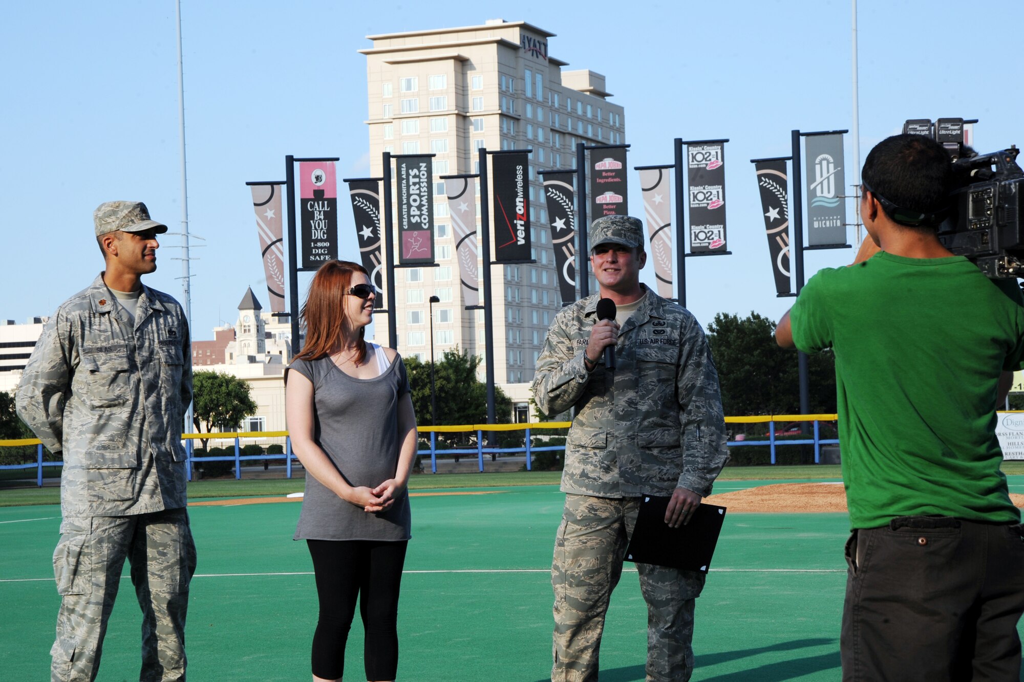 Staff Sgt. Eric Farley, 22nd Civil Engineer Squadron explosive ordnance disposal operator, speaks to media representatives from KAKE-TV at the Lawrence-Dumont Stadium, July 10, 2010, Wichita, Kan.  Sergeant Farley was being recognized as a hometown hero prior to the Wichita Wingnuts baseball game for his service at home, in Iraq and in Afghanistan and his ability to disable explosives to keep others safe.  (U.S. Air Force photo/Airman 1st Class Andrea Salazar)