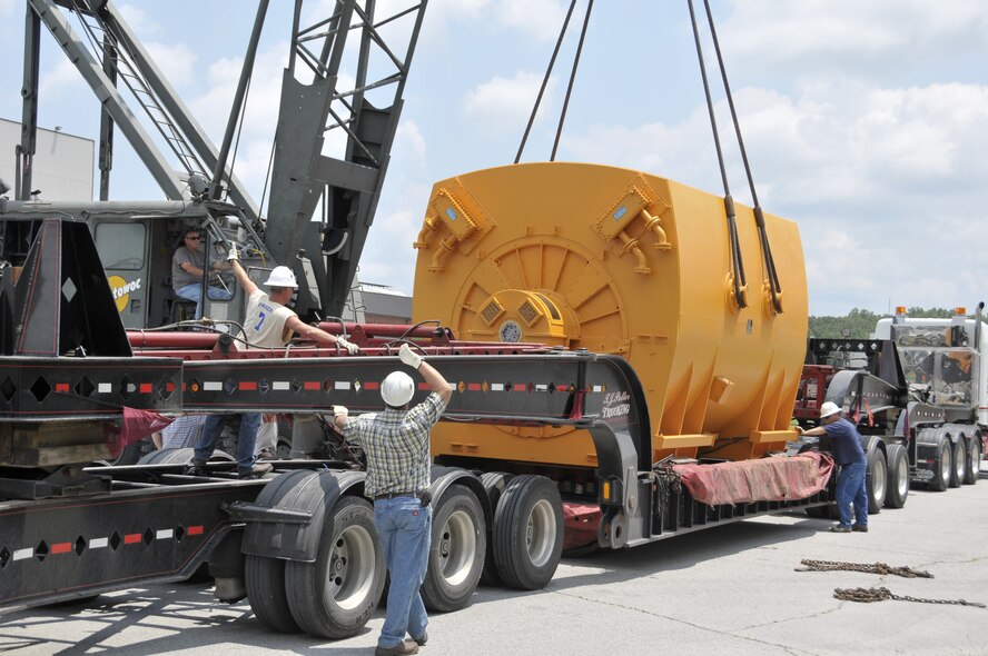 Joe Boyer, ATA crane operator, works with ATA riggers Wayne Brown, Stacy Parker, Jay Murdock and Nathan Colvin to lift the motor off it's transport trailer. (Photo by Rick Goodfriend)