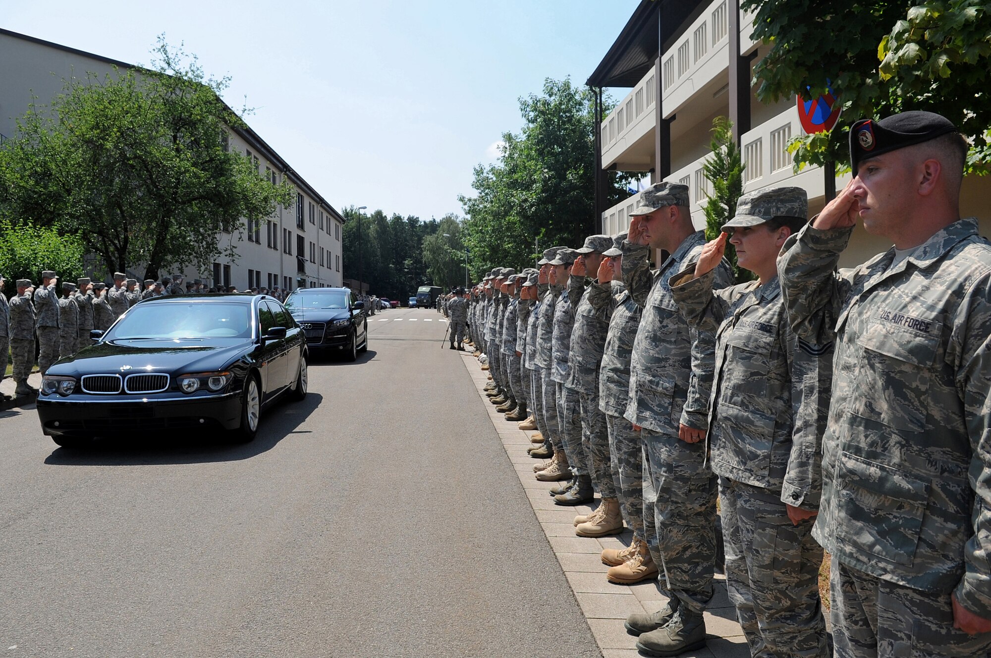 U.S. Air Forces in Europe Airmen salute Gen. Roger A. Brady, USAFE commander, as he leaves the Kisling NCO Academy auditorium after receiving his Order of the Sword invitation at Kapaun Air Station, Germany, July 14, 2010. General Brady will formally accept the honor during a ceremony in the fall at Ramstein Air Base, Germany. (U.S. Air Force photo illustration by Airman 1st Class Grovert Fuentes-Contreras)