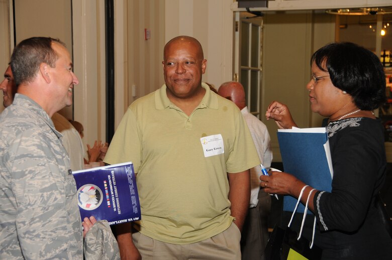 U.S. Air Force Master Sgt. Gary Greene of the Maryland Air National Guard’s 175th Maintenance Squadron and wife Anita speak with Lt. Col. Timothy F. Schuster, 175th Maintenance Group Commander during the Yellow Ribbon Reintegration Program. This was the first 30-day post-deployment YYRP held at the Sheraton Baltimore City Center Hotel on July 9-10. (U.S. Air Force photo by Master Sgt. Ed Bard/Released)