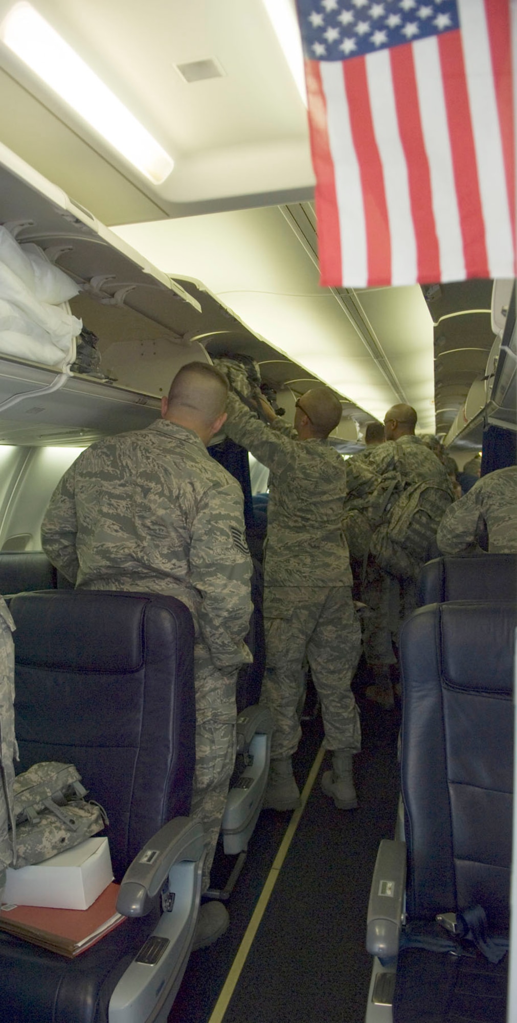 HANSCOM AIR FORCE BASE, Mass. – Airmen from Otis Air National Base, Mass., put away items on a commercial plane on July 9. Thirty-six security forces personnel departed from Hanscom for pre-deployment training at Eglin Air Force Base, Fla. This is the first time a large group of troops has left from the base for an AEF CC Pax mission, allowing Hanscom’s installation deployment team to gain experience in these types of scenarios and work with other units from throughout the region. (U.S. Air Force photo by Mark Herlihy)