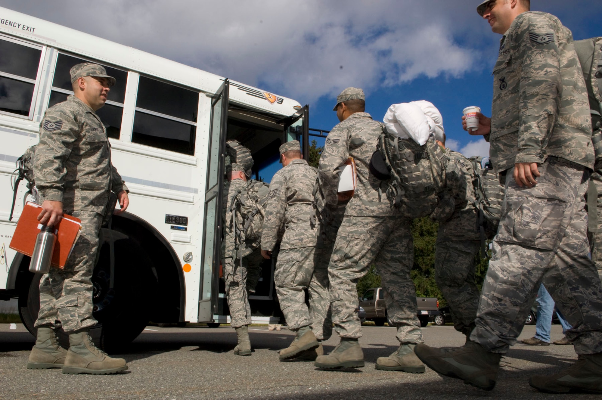 HANSCOM AIR FORCE BASE, Mass. – Airmen from Otis Air National Base, Mass., board a bus at the Installation Deployment Center on their way to the flight line on July 9. Thirty-six security forces personnel departed from Hanscom for pre-deployment training at Eglin Air Force Base, Fla. This is the first time a large group of troops has left from the base for an AEF CC Pax mission, allowing Hanscom’s installation deployment team to gain experience in these types of scenarios and work with other units from throughout the region. (U.S. Air Force photo by Mark Herlihy)