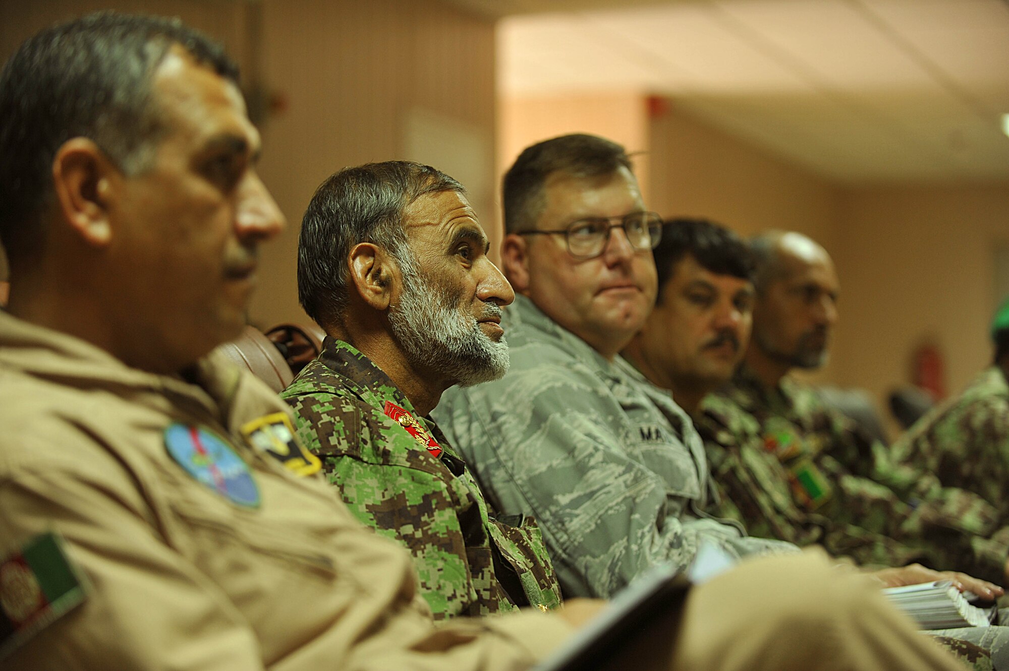 Afghan Air Force Brig. Gen. Haji Yousef, center, and U.S. Air Force Col. Bernard Mater, right, listen to U.S. Air Force personnel of the 738th Air Expeditionary Advisory Group conduct a mishap safety briefing for a command post exercise at Kandahar Airfield, Afghanistan July 7, 2010.  The briefing was a table top meeting with members of the Afghan Air Force and advisors from the 738 AEAG prior to a downed aircraft exercise that will be held at Kandahar Airfield, Afghanistan.  General Yousef is the deputy commander of the Kandahar Air Wing and Colonel Mater is the commander of the 738 AEAG.  (U.S. Air Force photo/Staff Sgt. Quinton Russ/released)
