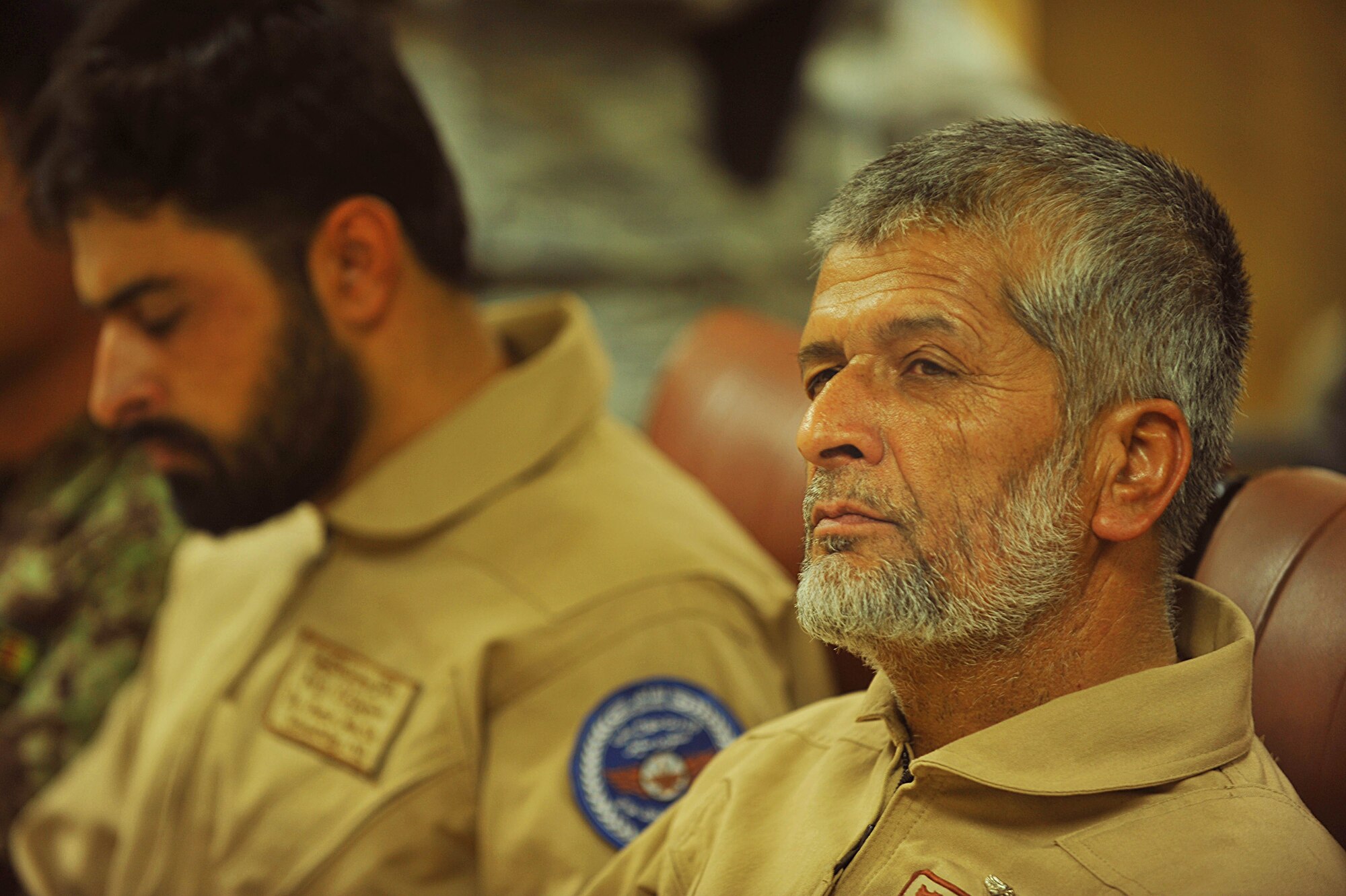 An Afghan Air Force member listens to U.S. Air Force personnel of the 738th Air Expeditionary Advisory Group conduct a mishap safety briefing for a command post exercise at Kandahar Airfield July 7, 2010.  The briefing was a table top meeting with members of the Afghan Air Force and advisors from the 738 AEAG prior to a downed aircraft exercise that will be held at Kandahar Airfield, Afghanistan.  (U.S. Air Force photo/Staff Sgt. Quinton Russ/released)