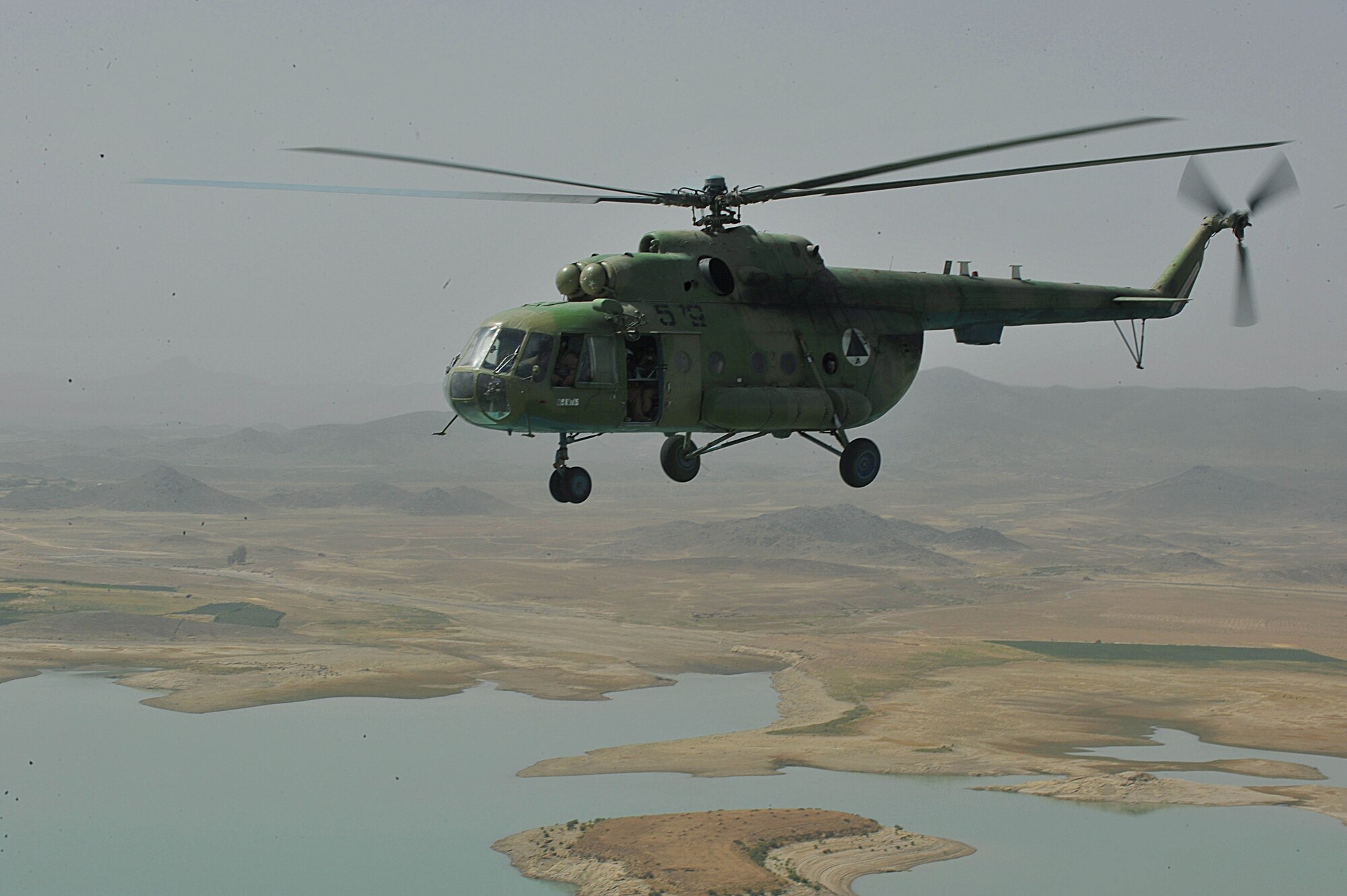 An Mi-17 helicopter flies over Afghanistan during a troop and supply movement June 29, 2010.  Members of the 738th Air Expeditionary Advisory Group are responsible for training and mentoring the Afghanistan National Army Air Force. (U.S. Air Force photo/Staff Sgt. Quinton Russ/released)