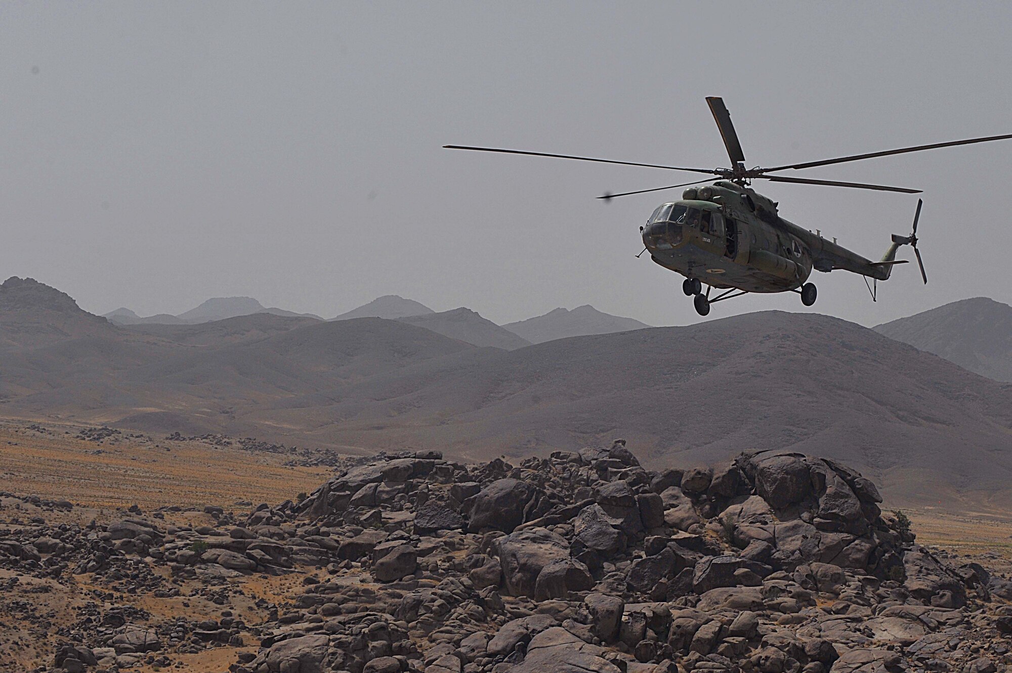 An Mi-17 helicopter flies over Afghanistan during a troop and supply movement June 29, 2010.    Members of the 738th Air Expeditionary Advisory Group are responsible for training and mentoring the Afghanistan National Army Air Force. (U.S. Air Force photo/Staff Sgt. Quinton Russ/released)