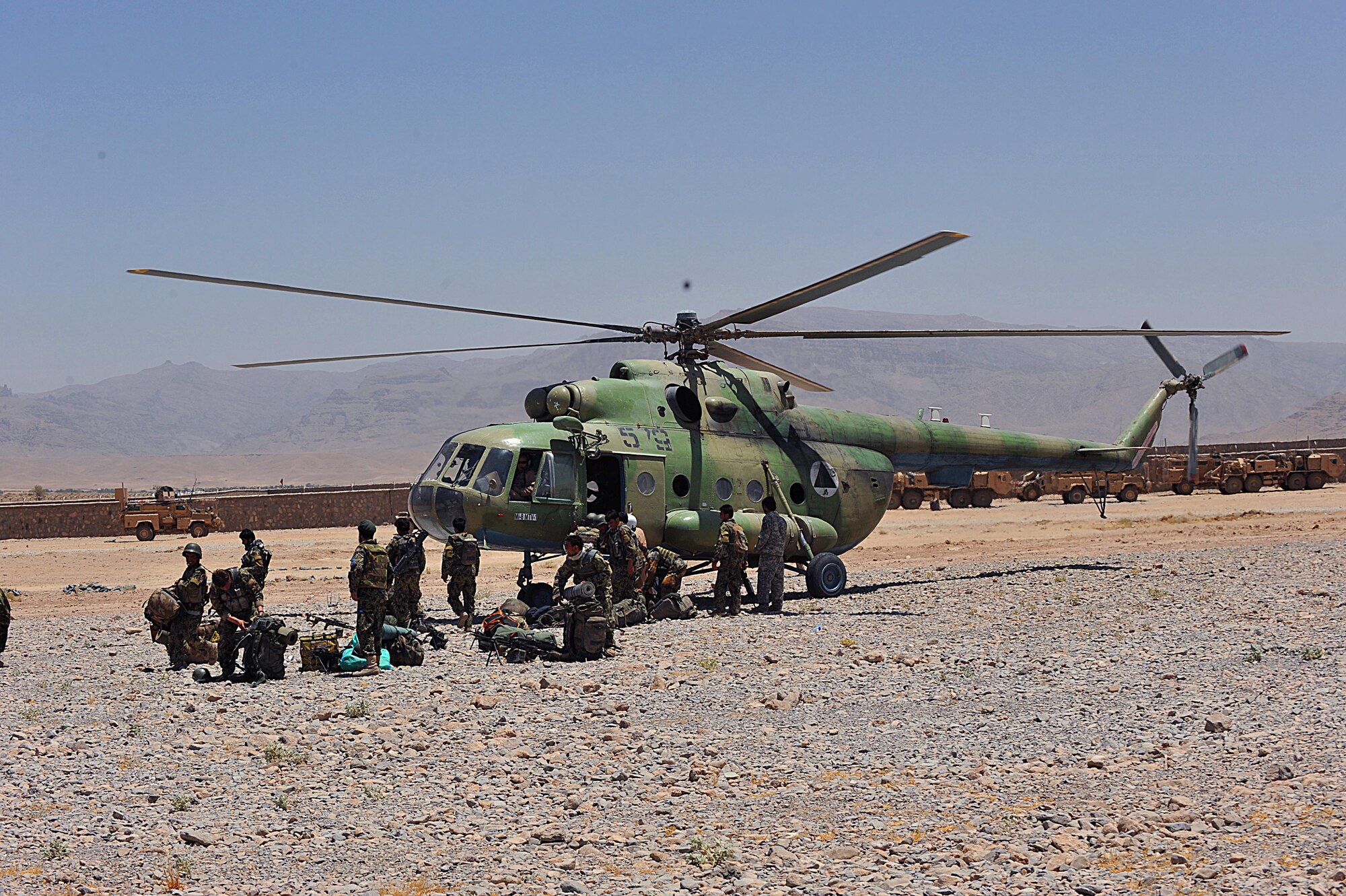 Afghan National Air Force airmen unload from an Mi-17 helicopter at forward operating base Tycz, Afghanistan June 29, 2010.  Members of the 738th Air Expeditionary Advisory Group are responsible for training and mentoring the Afghanistan National Army Air Force. (U.S. Air Force photo/Staff Sgt. Quinton Russ/released)