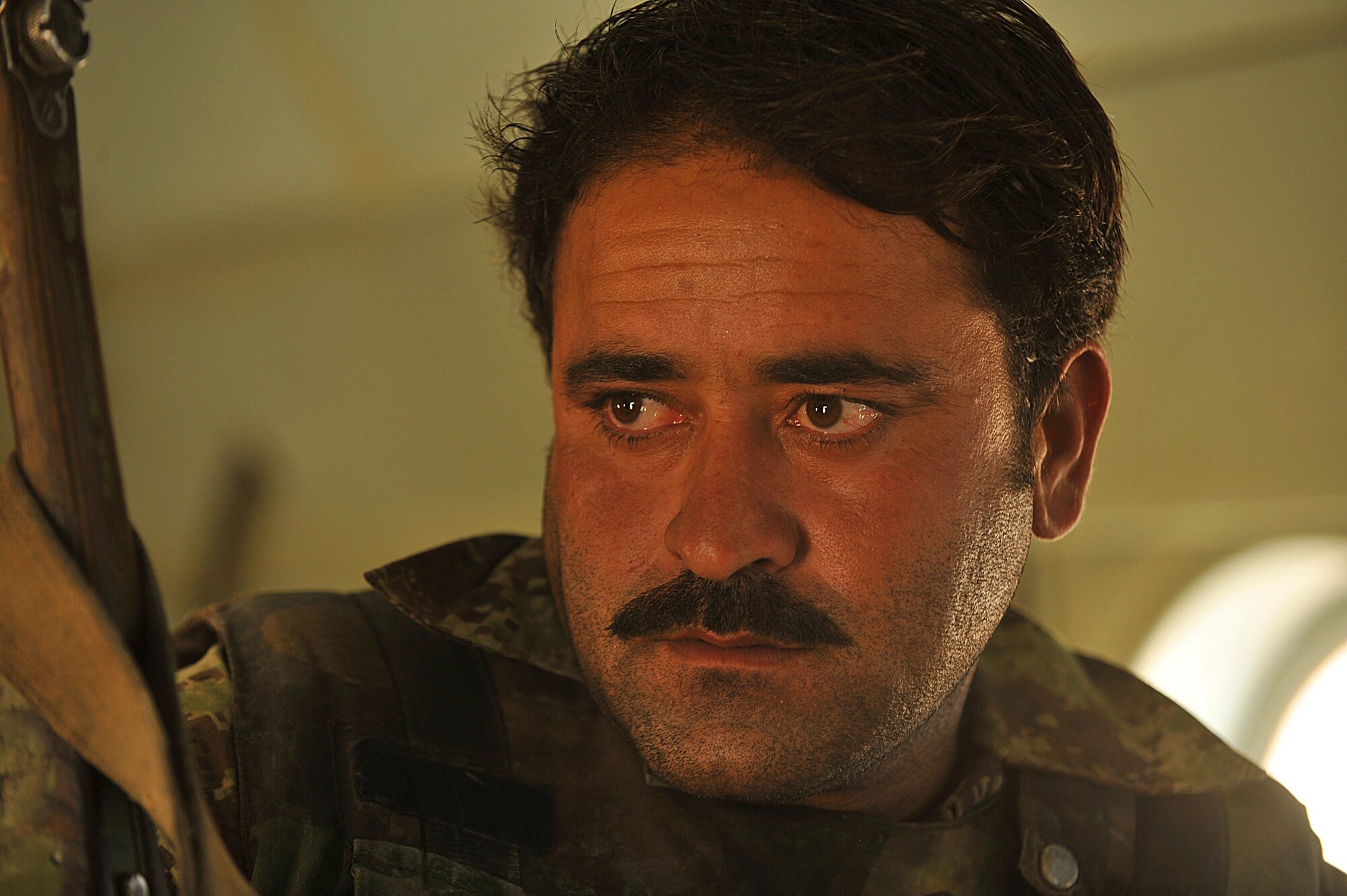 An Afghan Air Force airman rides in an Mi-17 helicopter to forward operating base Tycz, Afghanistan June 29, 2010.  Members of the 738th Air Expeditionary Advisory Group are responsible for training and mentoring the Afghanistan National Army Air Force. (U.S. Air Force photo/Staff Sgt. Quinton Russ/released)