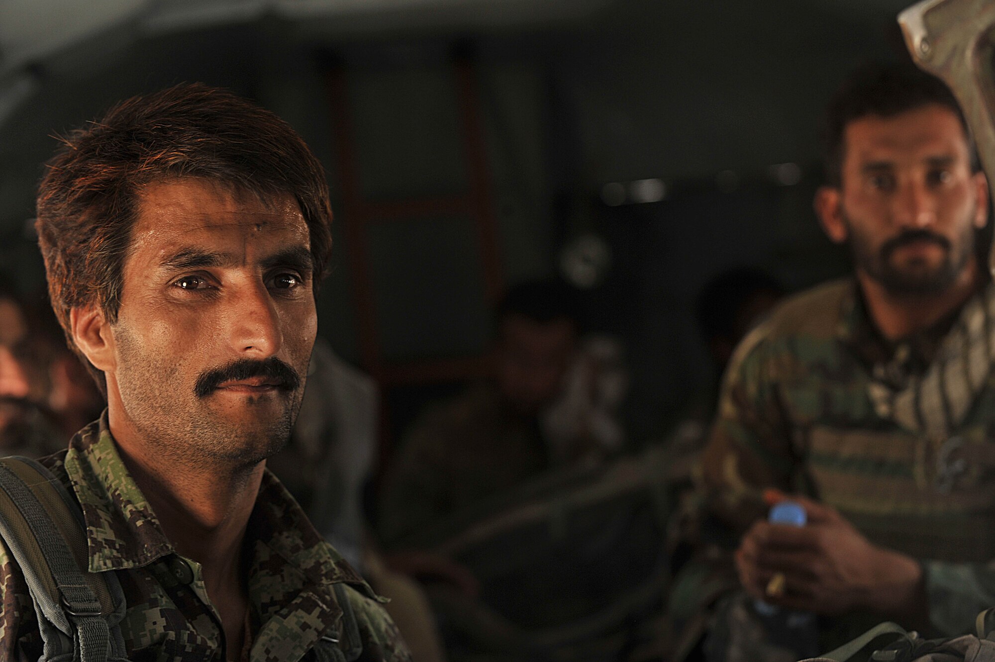 Afghan Air Force airmen ride in an Mi-17 helicopter to forward operating base Tycz, Afghanistan June 29, 2010.  Members of the 738th Air Expeditionary Advisory Group are responsible for training and mentoring the Afghanistan National Army Air Force. (U.S. Air Force photo/Staff Sgt. Quinton Russ/released)