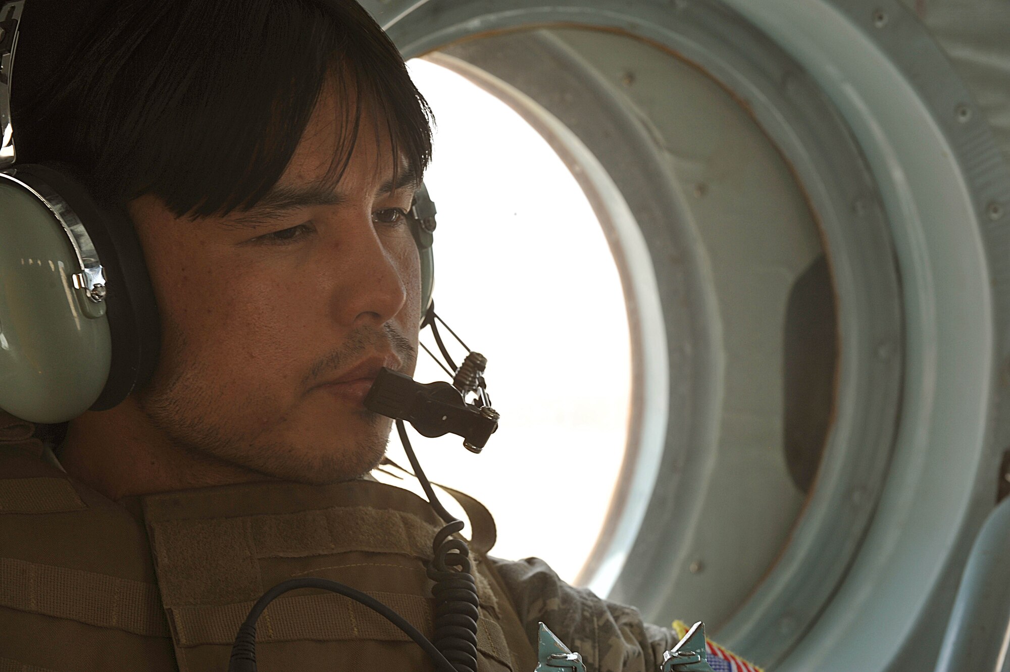 U.S. interpreter Sharef Bastani interprets a conversation between American and Afghan pilots during a troop and supply movement in Afghanistan June 29, 2010.  Members of the 738th Air Expeditionary Advisory Group are responsible for training and mentoring the Afghanistan National Army Air Force. (U.S. Air Force photo/Staff Sgt. Quinton Russ/released)