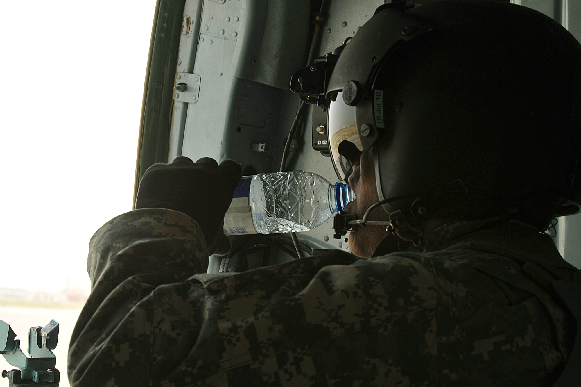 U.S. Army Sgt. 1st Class David Lara takes a water break during troop and supply movement at forward operating base Tycz, Afghanistan June 29, 2010.  Sergeant Lara is a flight medic deployed to the 738th Air Expeditionary Advisory Group.  Members of the 738 AEAG are responsible for training and mentoring the Afghanistan National Army Air Force. (U.S. Air Force photo/Staff Sgt. Quinton Russ/released)