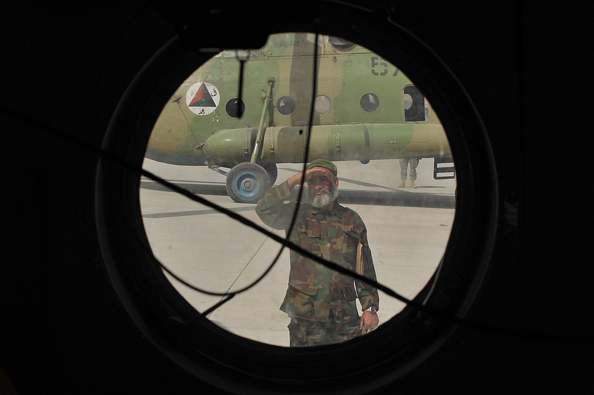 An Afghan Air Force maintainer watches as an Mi-17 helicopter prepares to taxi out for a troop and supply movement mission at Kandahar Airfield, Afghanistan June 29, 2010.  Members of the 738th Air Expeditionary Advisory Group are responsible for training and mentoring the Afghanistan National Army Air Force. (U.S. Air Force photo/Staff Sgt. Quinton Russ/released)