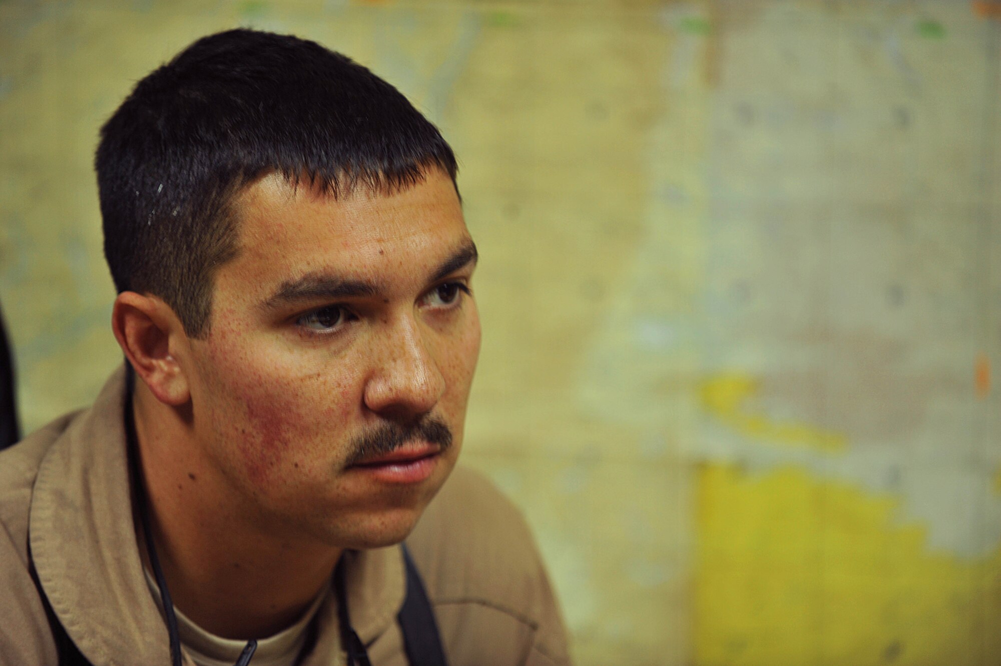 U.S. Air Force Capt. Clell Knight listens to a crew briefing for a troop and supply movement at Kandahar Airfield, Afghanistan June 29, 2010.  Captain Knight is a pilot deployed to the 738th Air Expeditionary Advisory Group.  Members of the 738 AEAG are responsible for training and mentoring the Afghanistan National Army Air Force. (U.S. Air Force photo/Staff Sgt. Quinton Russ/released)