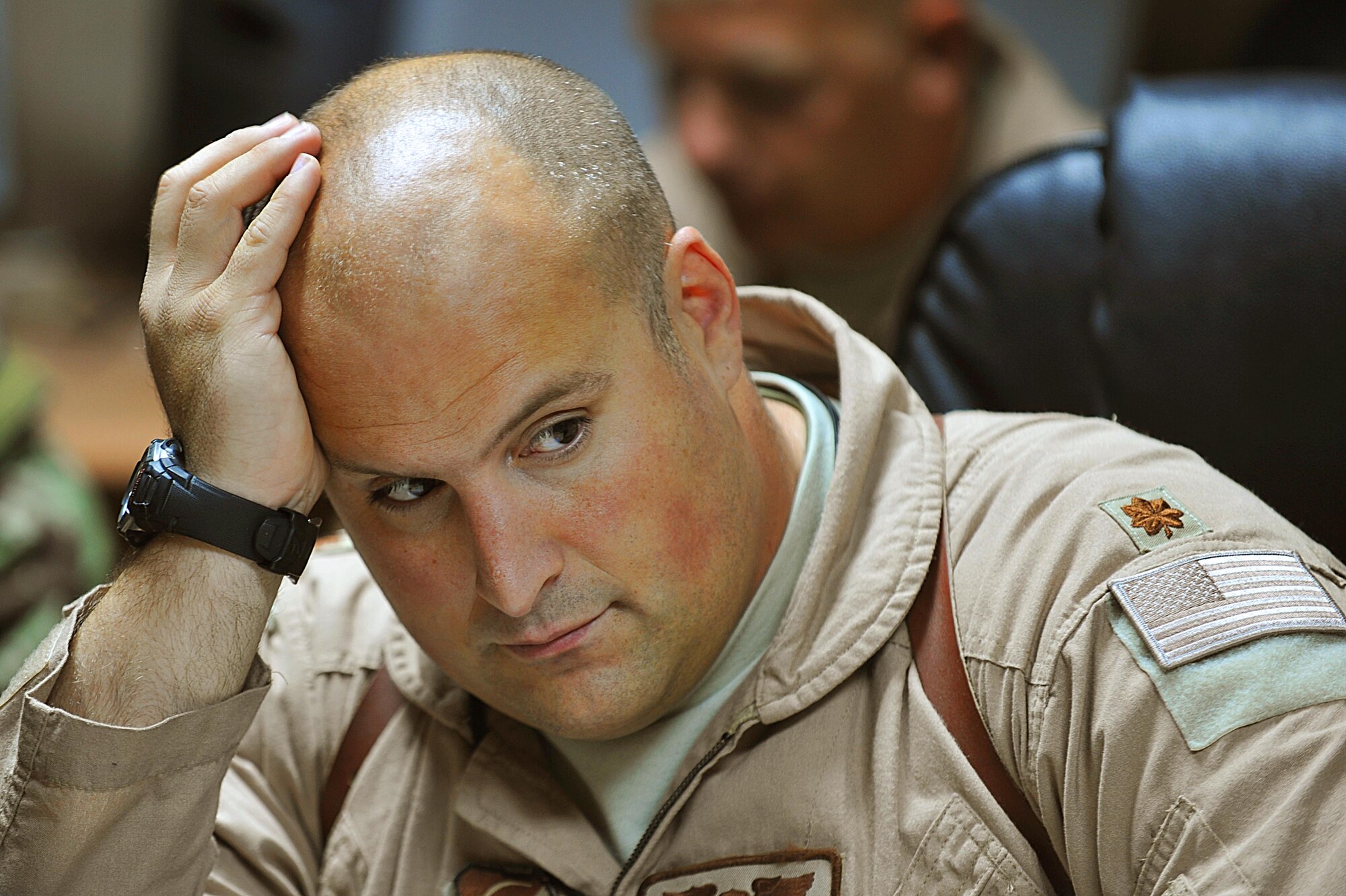 U.S. Air Force Maj. Micah West listens to a crew briefing for troop and supply movement at Kandahar Airfield, Afghanistan June 29, 2010. Major West is a pilot deployed to the 738th Air Expeditionary Advisory Group.  Members of the 738 AEAG are responsible for training and mentoring the Afghanistan National Army Air Force. (U.S. Air Force photo/Staff Sgt. Quinton Russ/released)