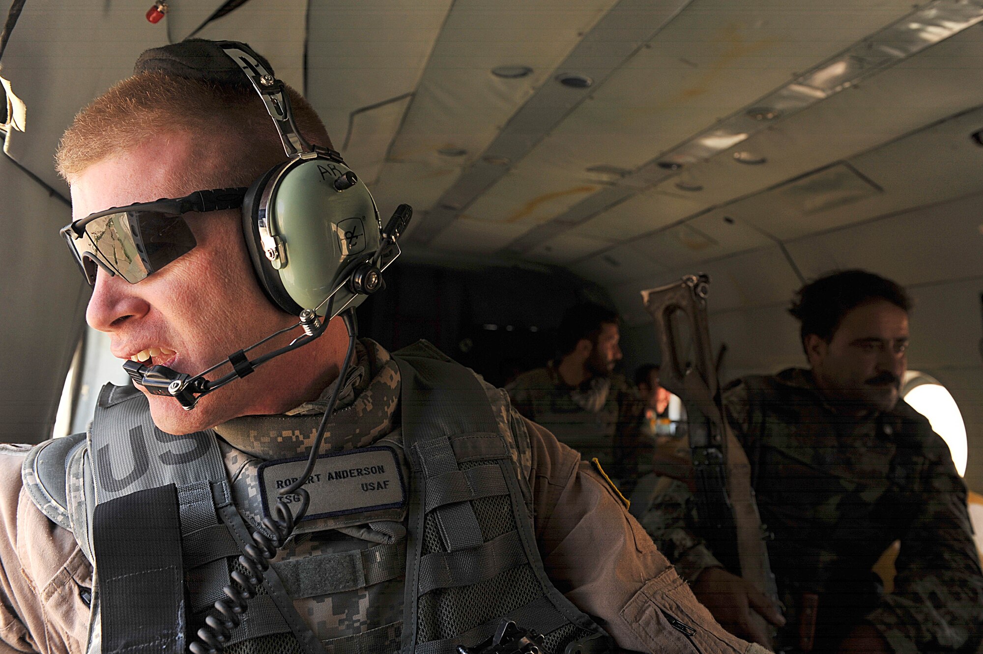 U.S. Air Force Tech. Sgt. Robert Anderson scans his area in an Mi-17 helicopter at Kandahar Airfield, Afghanistan June 29, 2010.  Sergeant Anderson is a maintenance advisor deployed to the 738th Air Expeditionary Advisory Group.  Members of the 738 AEAG are responsible for training and mentoring the Afghanistan National Army Air Force.  (U.S. Air Force photo/Staff Sgt. Quinton Russ/released)
