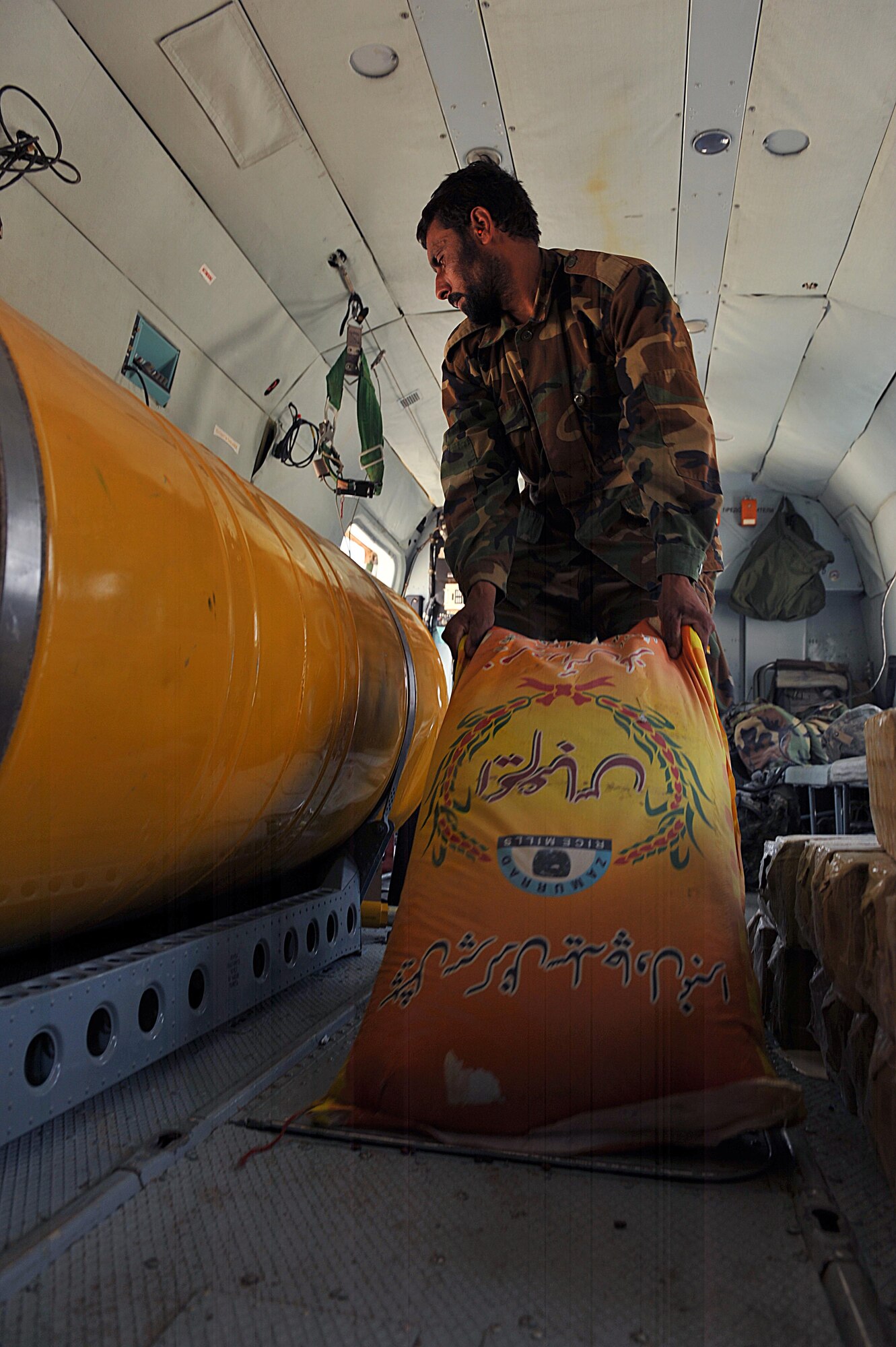 An Afghan Air Force member unloads supplies off of an Mi-17 helicopter during a troop and supply movement at forward operating base Tinsley, Afghanistan June 29, 2010.  Members of the 738th Air Expeditionary Advisory Group are responsible for training and mentoring the Afghanistan National Army Air Force. (U.S. Air Force photo/Staff Sgt. Quinton Russ/released)
