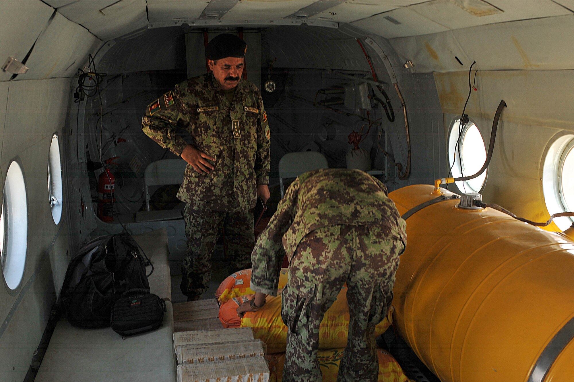 Afghan Air Force members load supplies on board of an Mi-17 helicopter during a troop and supply movement at Tereen-Kowt, Afghanistan June 29, 2010.  Members of the 738th Air Expeditionary Advisory Group are responsible for training and mentoring the Afghanistan National Army Air Force. (U.S. Air Force photo/Staff Sgt. Quinton Russ/released)