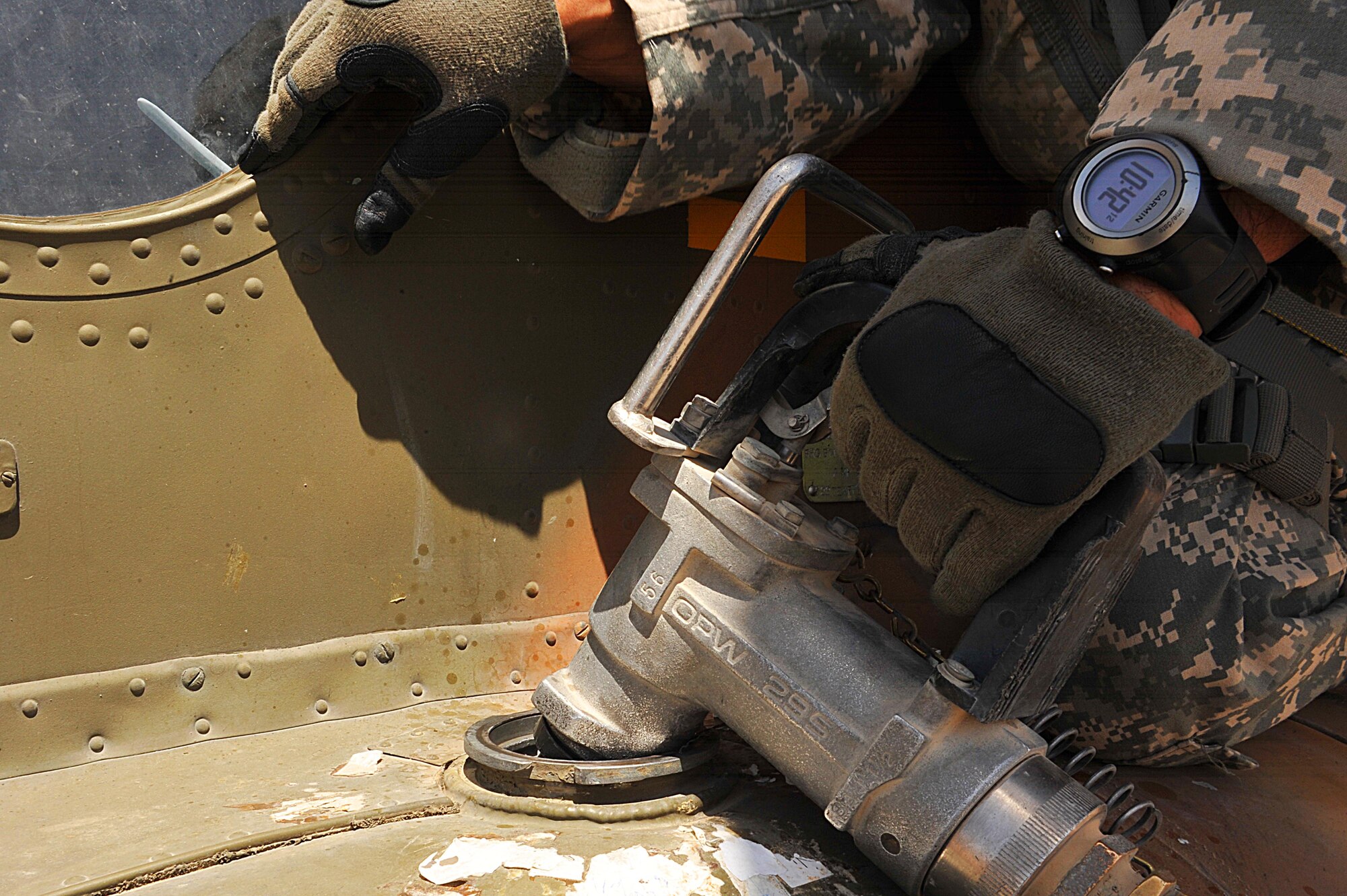 U.S. Army Sgt. 1st. Class David Lara refuels an Mi-17 helicopter during a troop and supply movement at Tereen-Kowt, Afghanistan June 29, 2010.  Sergeant Lara is a flight medic deployed to the 738th Air Expeditionary Advisory Group.  Members of the 738 AEAG are responsible for training and mentoring the Afghanistan National Army Air Force. (U.S. Air Force photo/Staff Sgt. Quinton Russ/released)