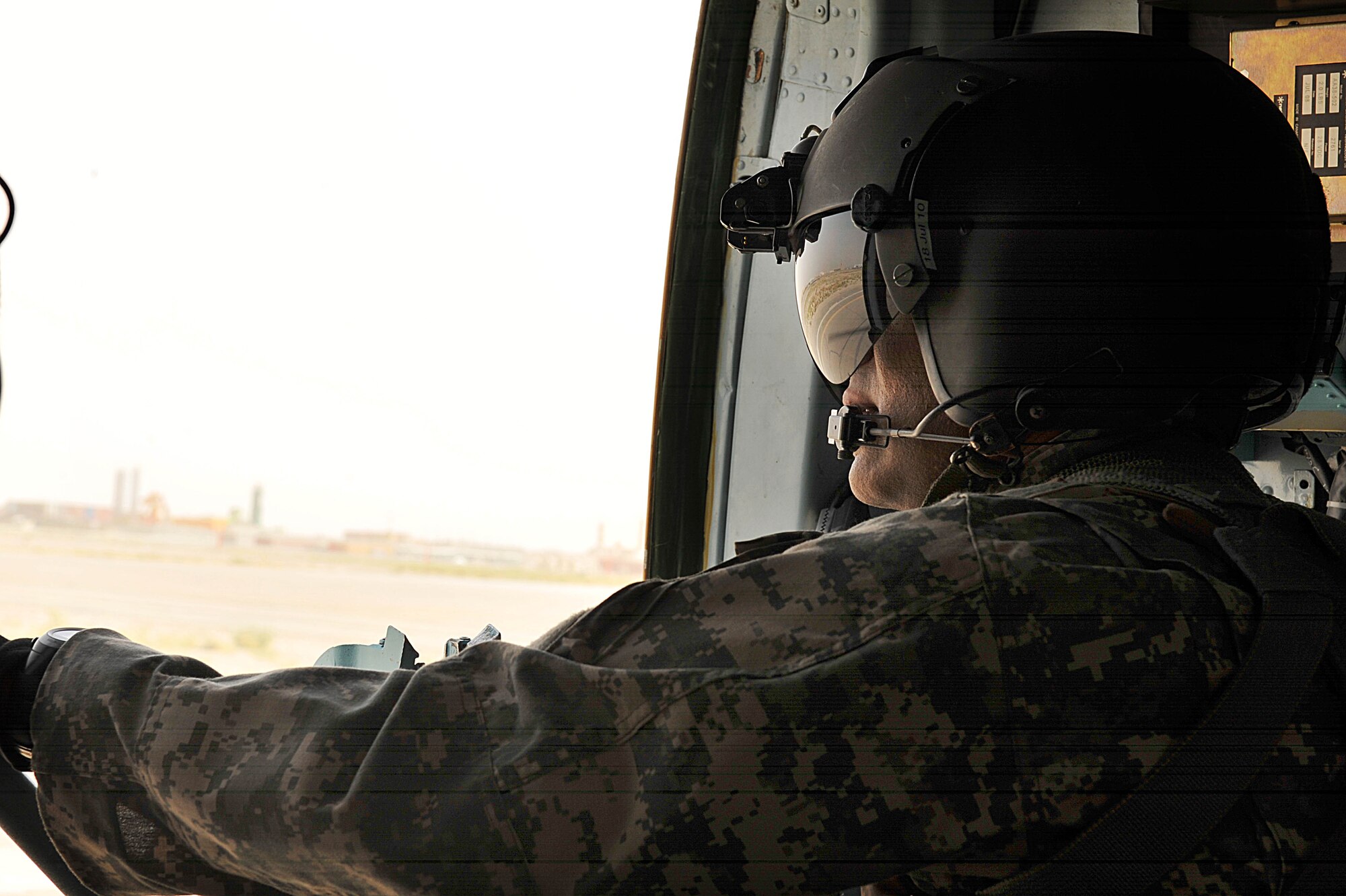 U.S. Army Sgt. 1st Class David Lara scans his area in an Mi-17 helicopter at over Afghanistan June 29, 2010.  Sergeant Lara is a flight medic deployed to the 738th Air Expeditionary Advisory Group.  Members of the 738 AEAG are responsible for training and mentoring the Afghanistan National Army Air Force. (U.S. Air Force photo/Staff Sgt. Quinton Russ/released)