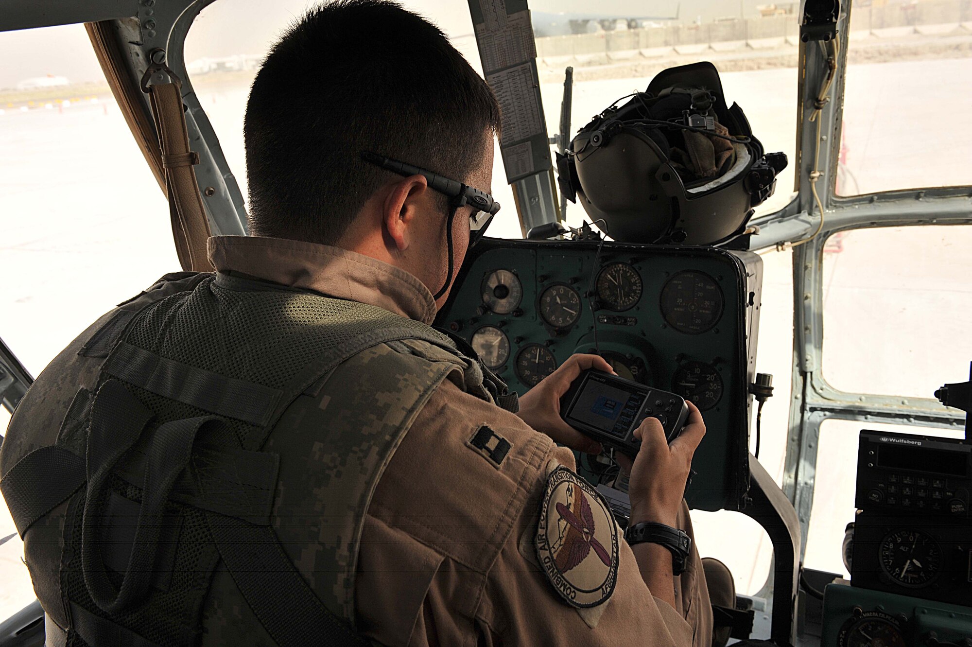 U.S. Air Force Capt. Clell Knight sets a GPS system before taking off in an Mi-17 helicopter at Kandahar Airfield, Afghanistan June 29, 2010.  Capt. Knight is a pilot deployed to the 738th Air Expeditionary Advisory Group.  Members of the 738 AEAG are responsible for training and mentoring the Afghanistan National Army Air Force.  (U.S. Air Force photo/Staff Sgt. Quinton Russ/released)