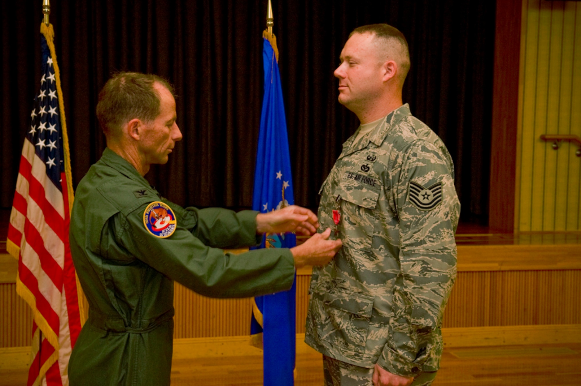 MISAWA AIR BASE, Japan – Tech. Sgt. Rory Stark, 35th Civil Engineer Squadron explosive ordnance disposal technician, receives a Bronze Star medal from Col. David Stilwell, 35th Fighter Wing commander, July 2, for his actions in Afghanistan.(U.S. Air Force photo/Senior Airman Jessica Lockoski) 