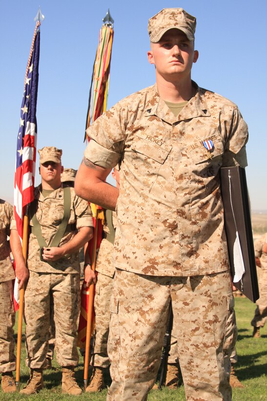 Corporal Daniel Hickey, a team leader with 2nd Battalion, 7th Marine Regiment, stands tall bearing his Silver Star and holding his award citation in front of the color guard and his battalion at Lance Cpl. Torrey Gray Field, July 16.