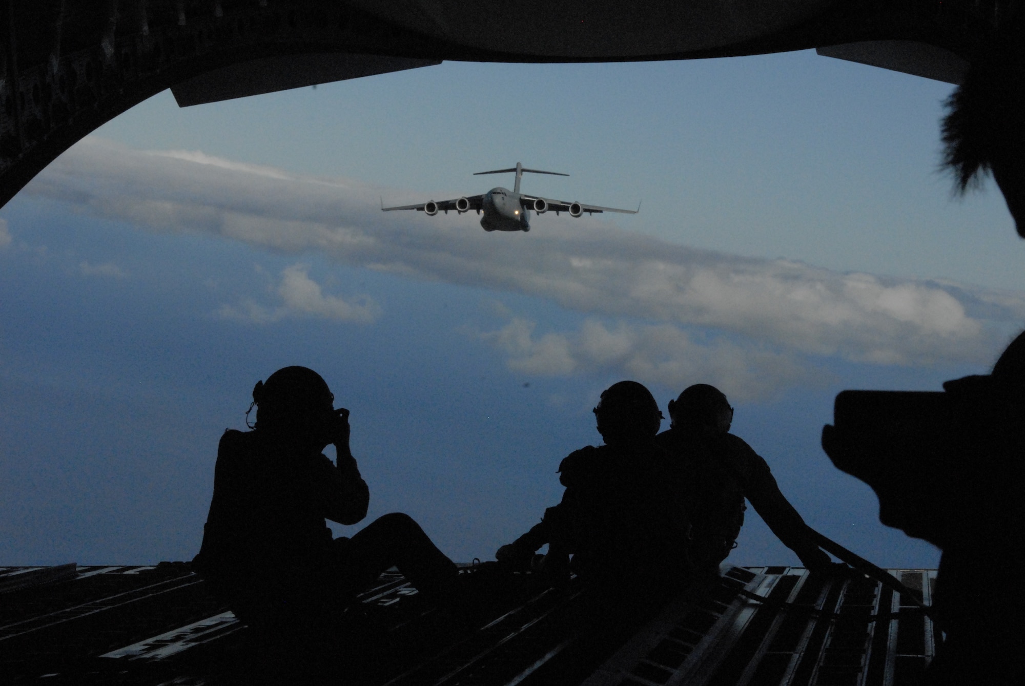 Media members photograph a C-17 Globemaster III during the Rim of the Pacific exercise July 16, 2010. Pacific Air Forces Airmen entered a new realm by demonstrating PACAF air drop capabilities to social media aboard two C-17 Globemaster IIIs. (U.S. Air Force photo/Tech. Sgt. Matthew McGovern)
