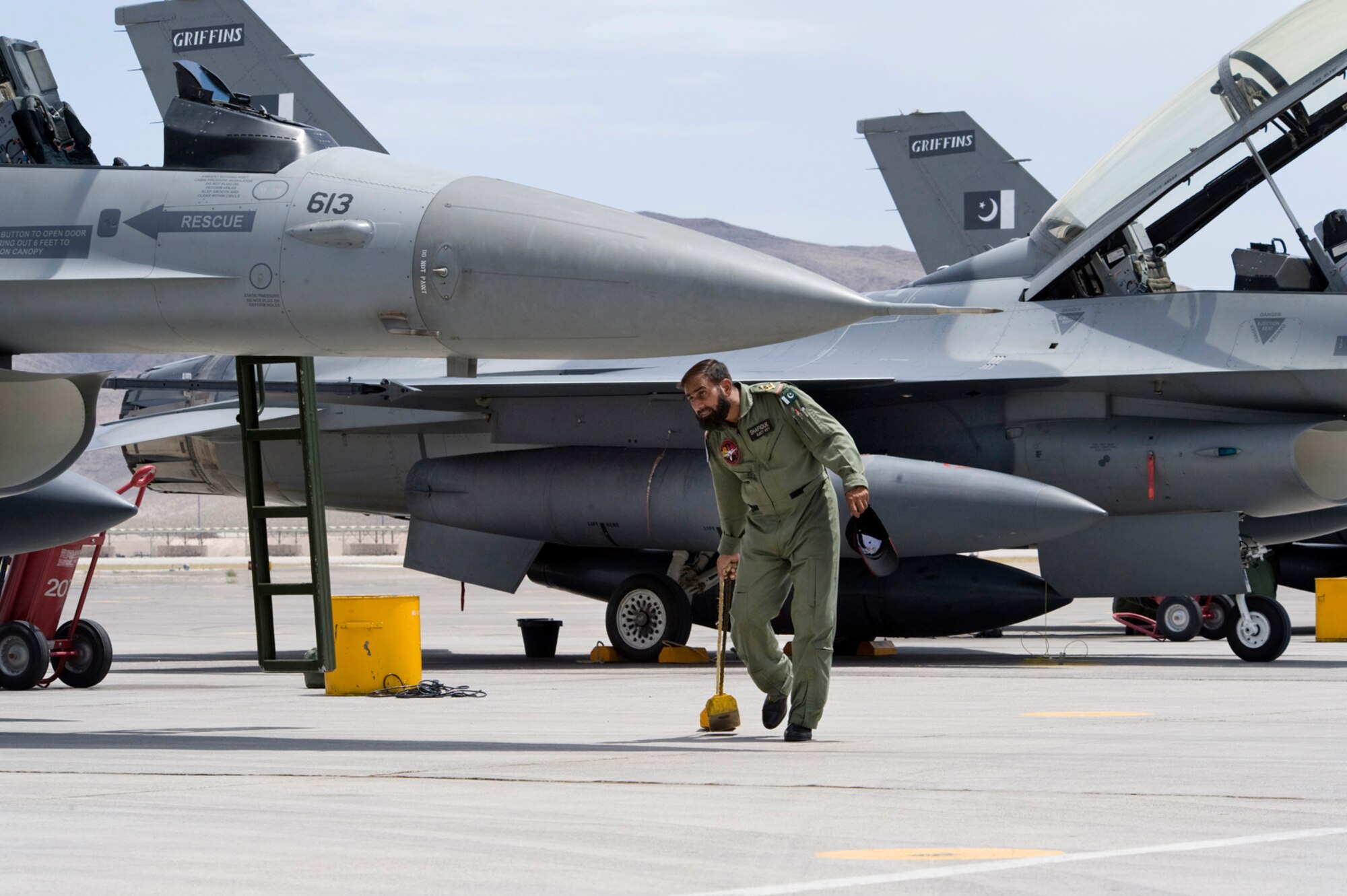 NELLIS AIR FORCE BASE, Nev.-- A Pakistan Air Force crew chief chalks an F-16 upon arrival for Red Flag 10-4 July 16.  The U.S. Air Force is hosting approximately 100 Pakistan Air Force pilots, maintainers and support personnel at Nellis Air Force Base for the world's premier large force employment and integration exercise July 17-31. This is the Pakistan Air Force's first time participating in Red Flag. (U.S. Air Force Photo by Lawrence Crespo)
