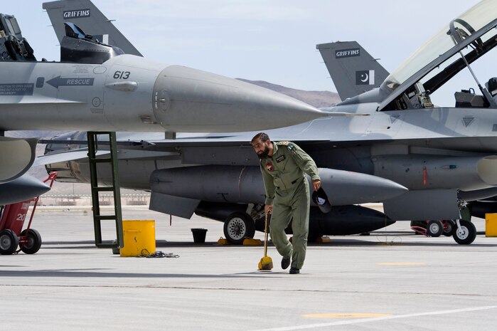 NELLIS AIR FORCE BASE, Nev.-- A Pakistan Air Force crew chief chalks an F-16 upon arrival for Red Flag 10-4 July 16.  The U.S. Air Force is hosting approximately 100 Pakistan Air Force pilots, maintainers and support personnel at Nellis Air Force Base for the world's premier large force employment and integration exercise July 17-31. This is the Pakistan Air Force's first time participating in Red Flag. (U.S. Air Force Photo by Lawrence Crespo)
