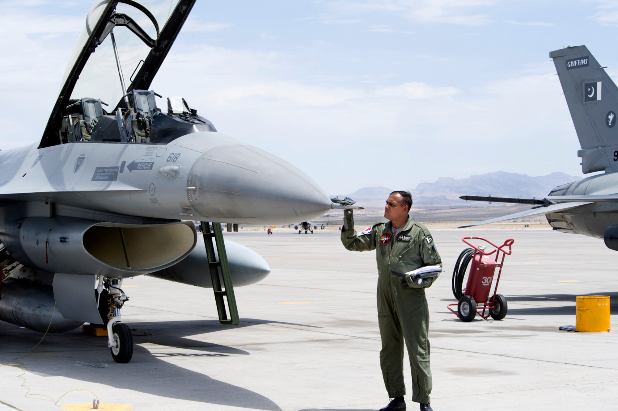 NELLIS AIR FORCE BASE, Nev.-- A Pakistan Air Force crew chief performs a post flight inspection on an F-16 Falcon after pilots and the aircraft arrive for Red Flag 10-4 July 16.  The U.S. Air Force is hosting approximately 100 Pakistan Air Force pilots, maintainers and support personnel at Nellis Air Force Base for the world's premier large force employment and integration exercise July 17-31. This is the Pakistan Air Force's first time participating in Red Flag. (U.S. Air Force Photo by Lawrence Crespo)

