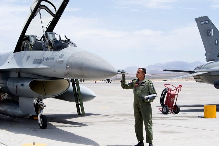 NELLIS AIR FORCE BASE, Nev.-- A Pakistan Air Force crew chief performs a post flight inspection on an F-16 Falcon after pilots and the aircraft arrive for Red Flag 10-4 July 16.  The U.S. Air Force is hosting approximately 100 Pakistan Air Force pilots, maintainers and support personnel at Nellis Air Force Base for the world's premier large force employment and integration exercise July 17-31. This is the Pakistan Air Force's first time participating in Red Flag. (U.S. Air Force Photo by Lawrence Crespo)
