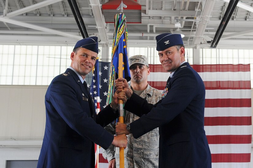 LANGLEY AIR FORCE BASE, Va -- Col. Matt Molloy, 1st Fighter Wing commander, presents the 1st Operations Group guidon to Col. Richard H. Boutwell, 1st Operations Group commander, during the change of command ceremony July 16. Col. Richard H. Boutwell assumed command of the 1st OG from Col. Dirk D. Smith. (U.S. Air Force photo/Staff Sgt. Ashley Hawkins)(RELEASED)