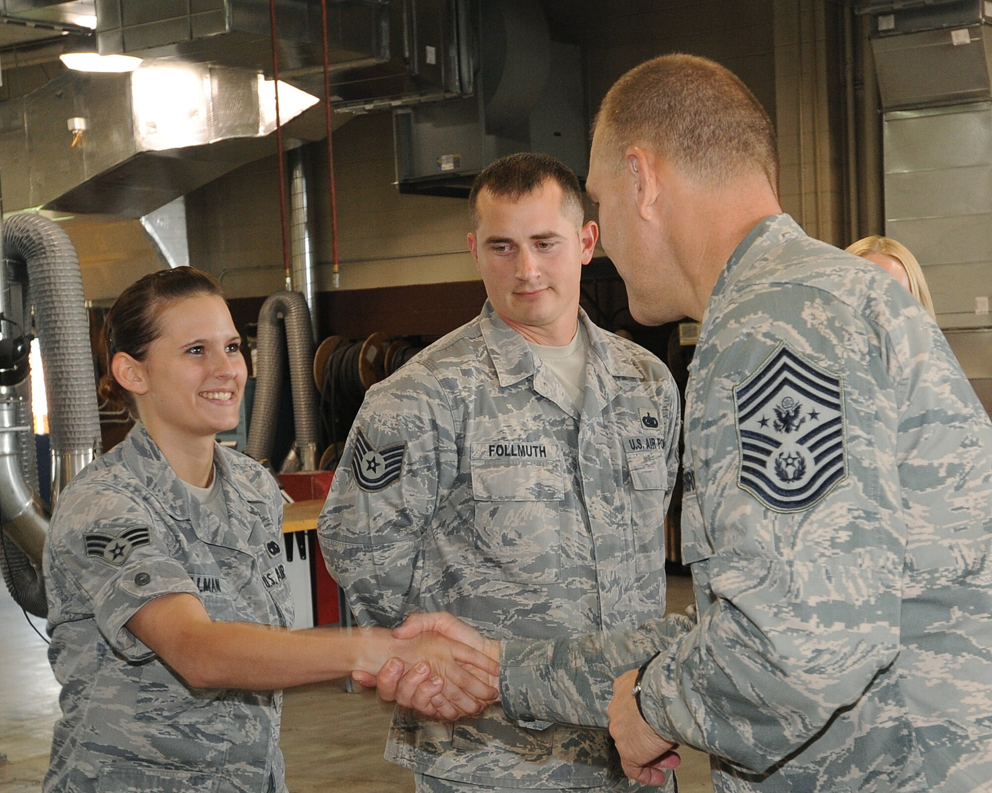 Senior Airman Jolene Bollman, 319th Logistics Readiness Squadron, shakes Chief Master Sgt. of the Air Force James A. Roy’s hand during a base visit July 14 to 16. Chief Roy met with Airmen from the 319th Air Refueling Wing and toured base facilities, which allowed him to witness first-hand how Grand Forks Air Force Base is preparing for the transition to a new mission.(U.S. Air Force photo by Tech. Sgt. Johnny Saldivar)