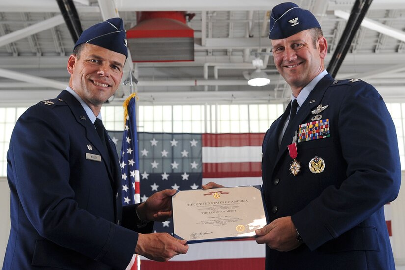 LANGLEY AIR FORCE BASE, Va -- Col. Dirk D. Smith, (right), receives the legion of merit medal from Col. Matt Molloy, 1st Fighter Wing commander, during the 1st Operations Group change of command ceremony July 16. Col. Richard H. Boutwell assumed command of the 1st OG from Col. Dirk D. Smith. (U.S. Air Force photo/Staff Sgt. Ashley Hawkins)(RELEASED)