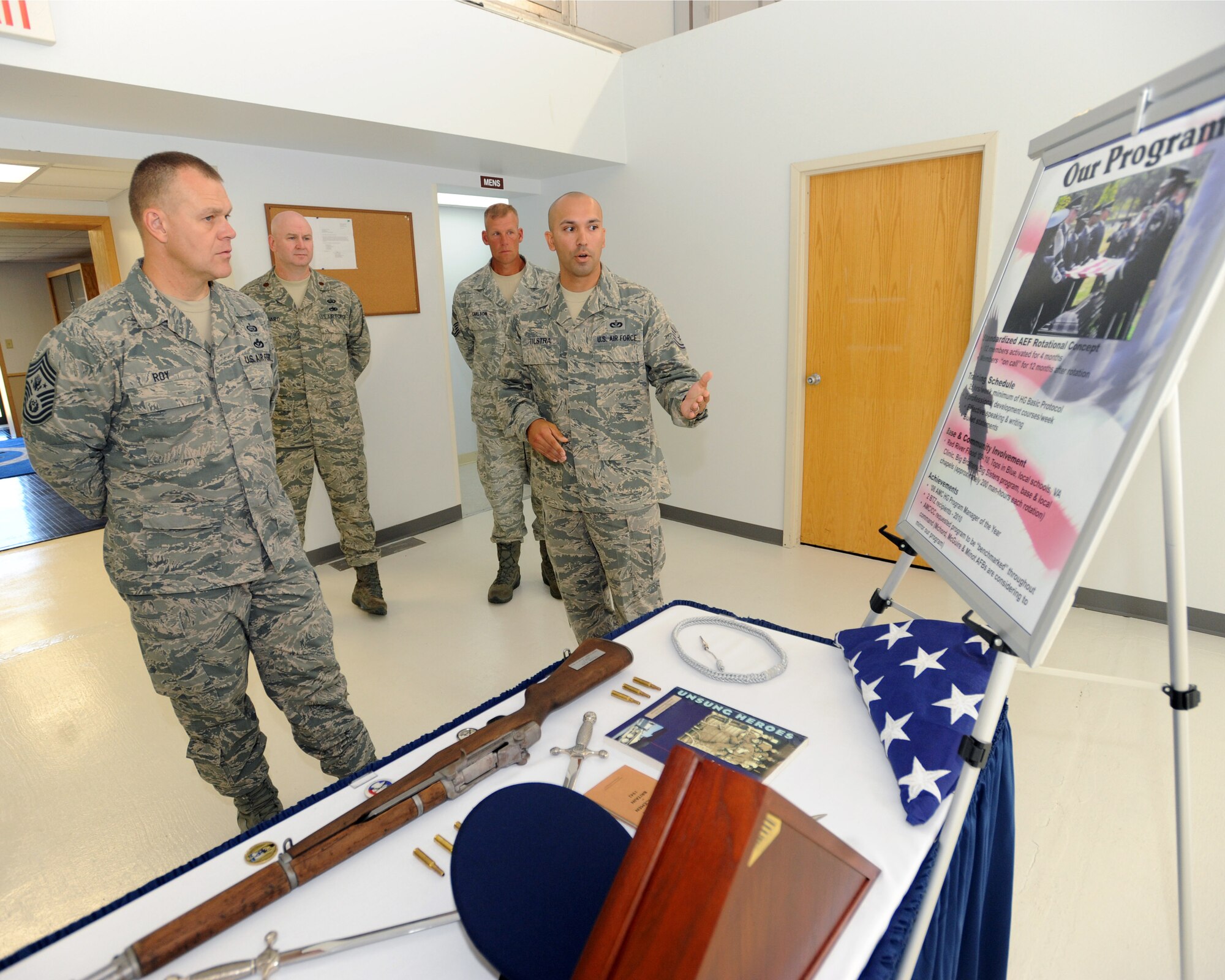 Tech. Sgt. Christopher Tilstra, 319th Force Support Squadron, explains the Grand Forks Air Force Base Honor Guard program to Chief Master Sgt. of the Air Force James A. Roy during a base visit July 14 to 16. Chief Roy met with Airmen from the 319th Air Refueling Wing and toured base facilities, which allowed him to witness first-hand how Grand Forks Air Force Base is preparing for the transition to a new mission. (U.S. Air Force photo by Tech. Sgt. Johnny Saldivar)